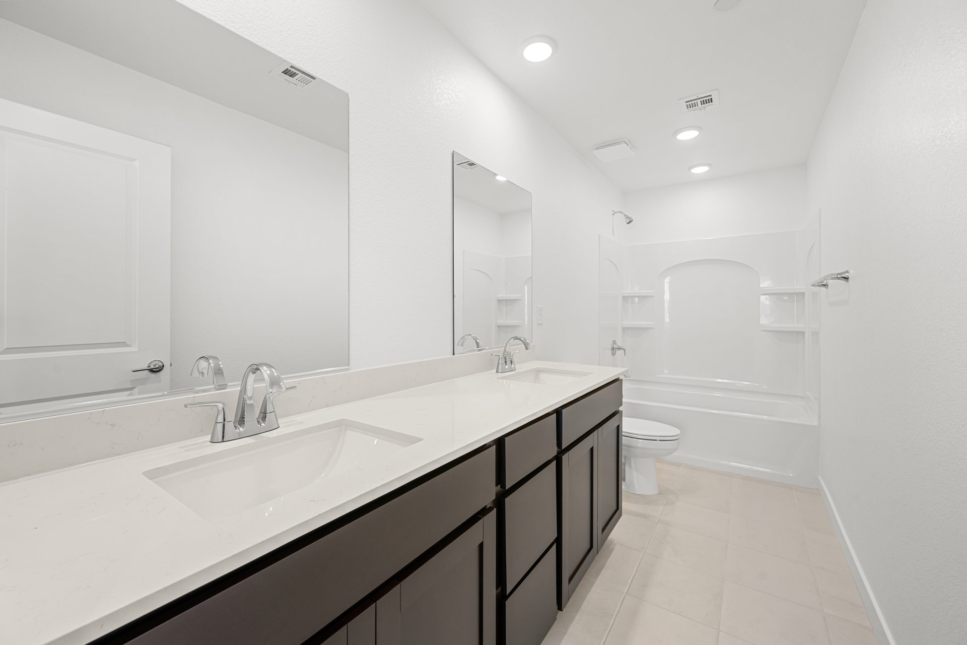 A bathroom with a tub sink and toilet.