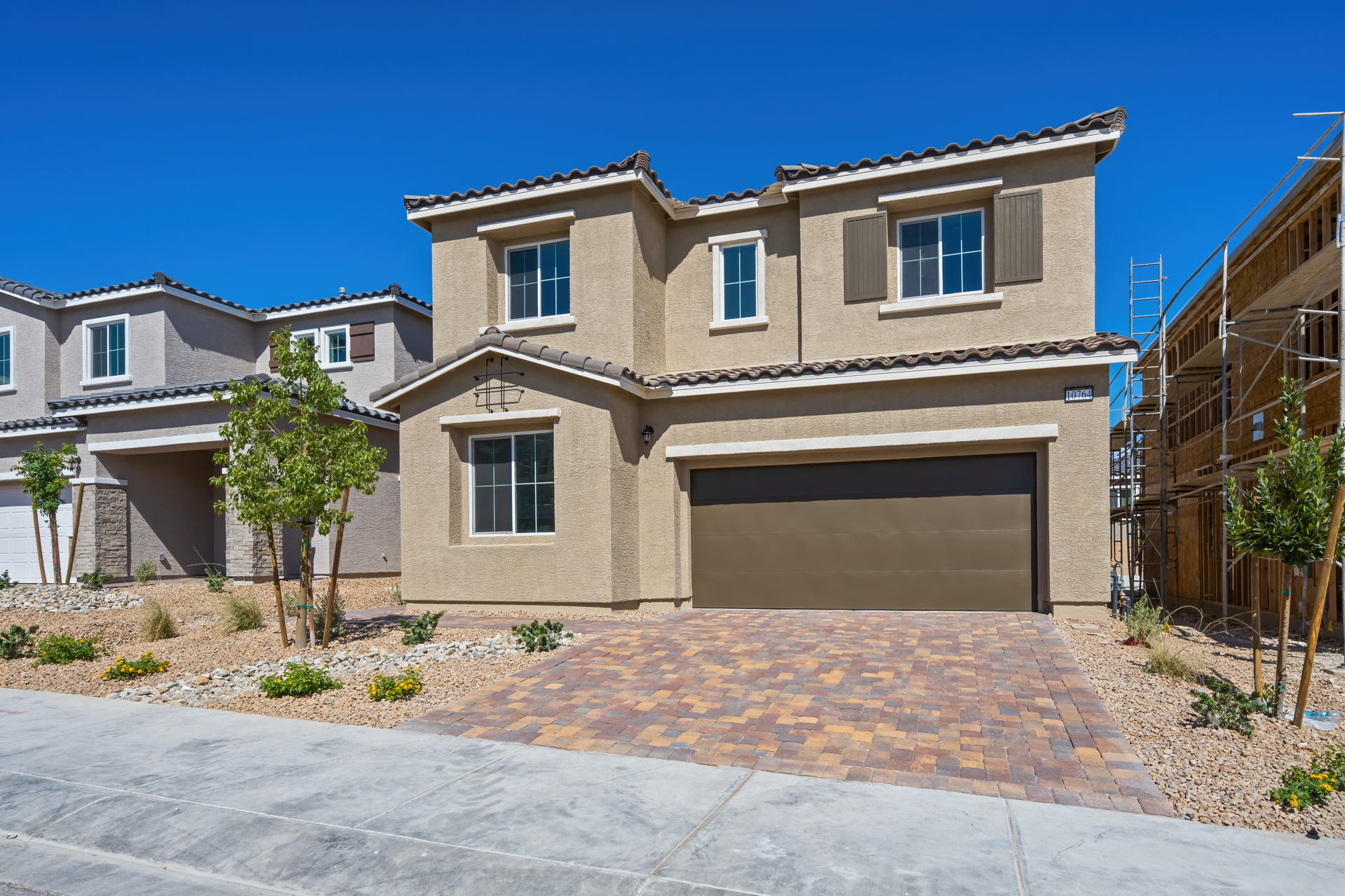 A house with a brick driveway.