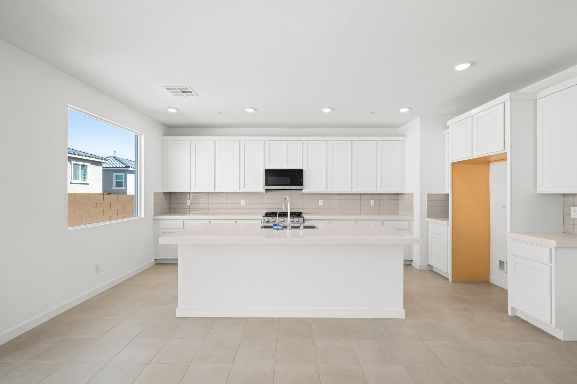 A kitchen with white cabinets.