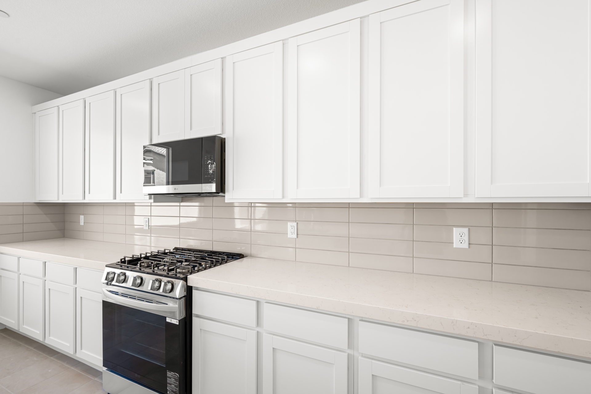 A kitchen with white cabinets.