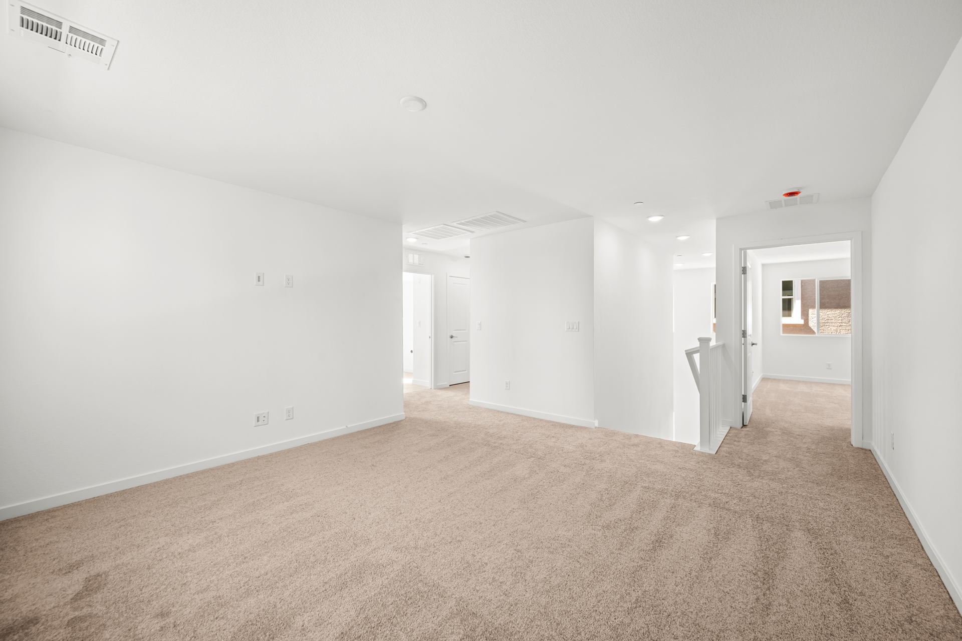 A long hallway with white walls.