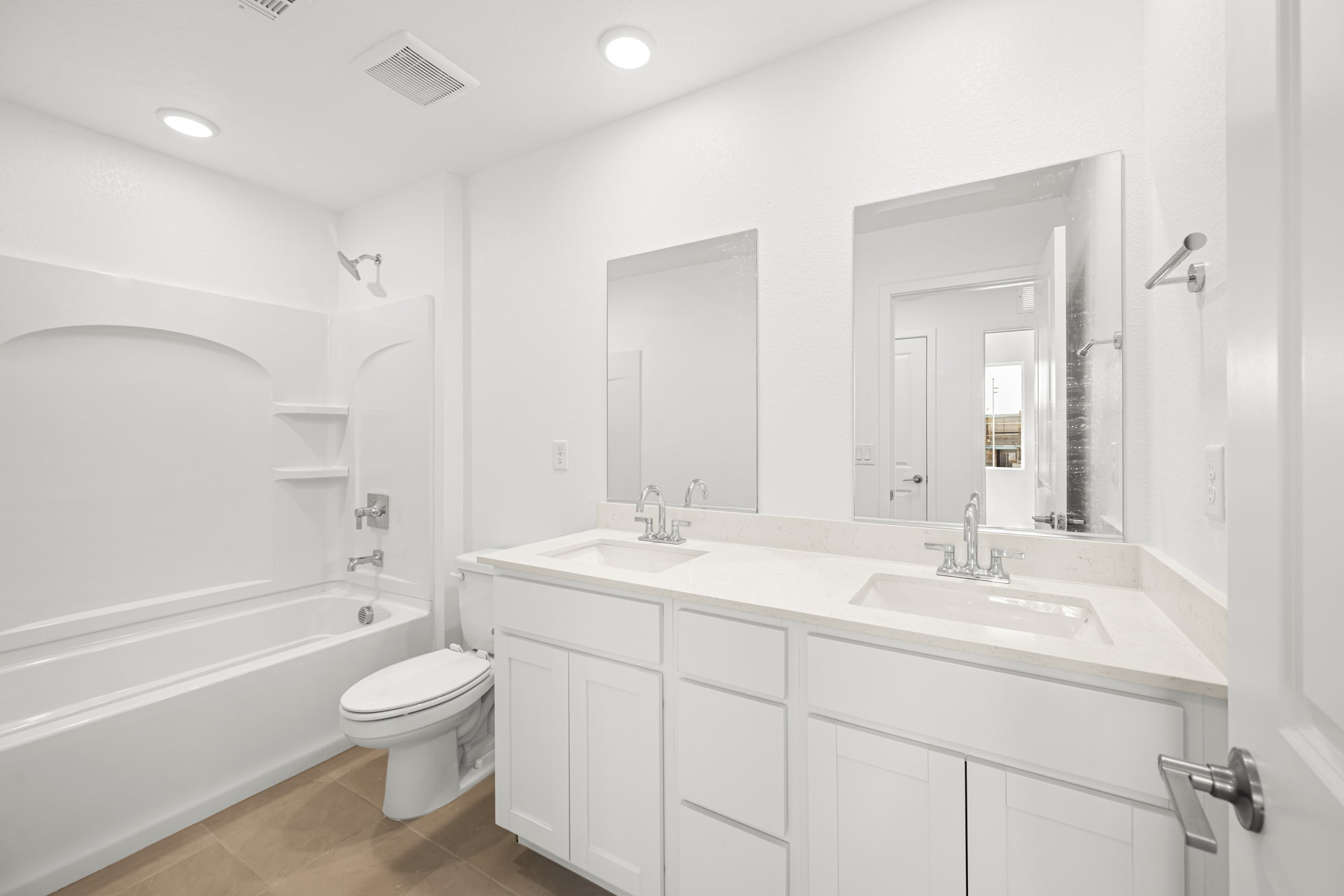 A bathroom with white cabinets.