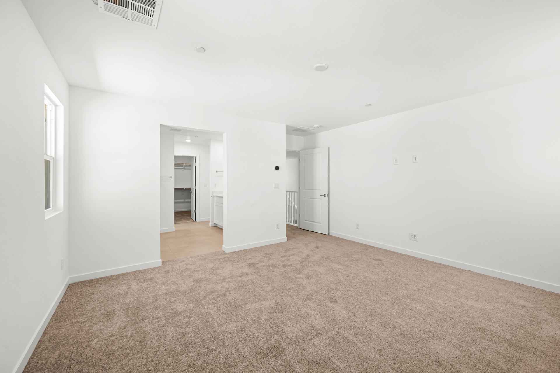 A long hallway with white walls.