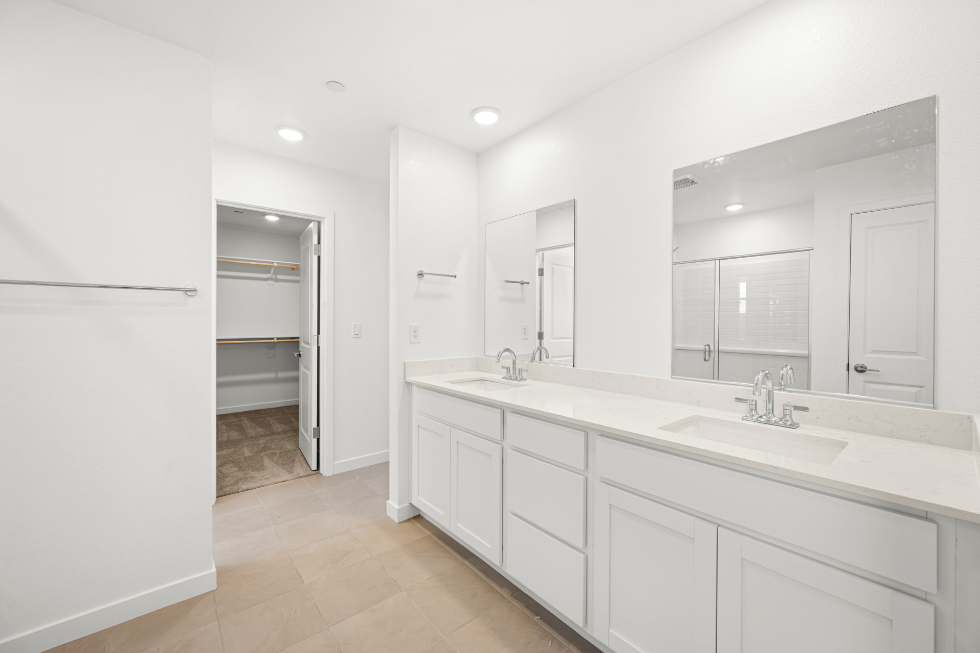 A bathroom with white cabinets.