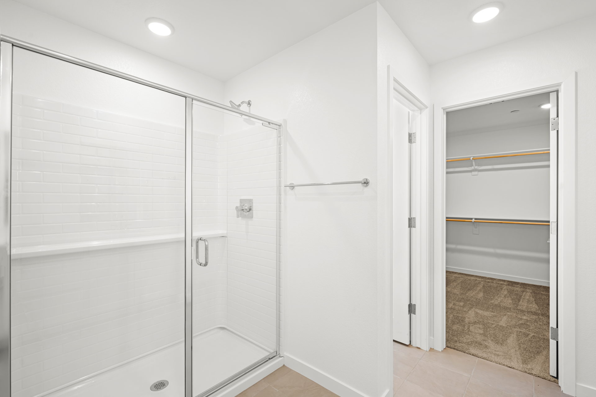A bathroom with white shower doors.