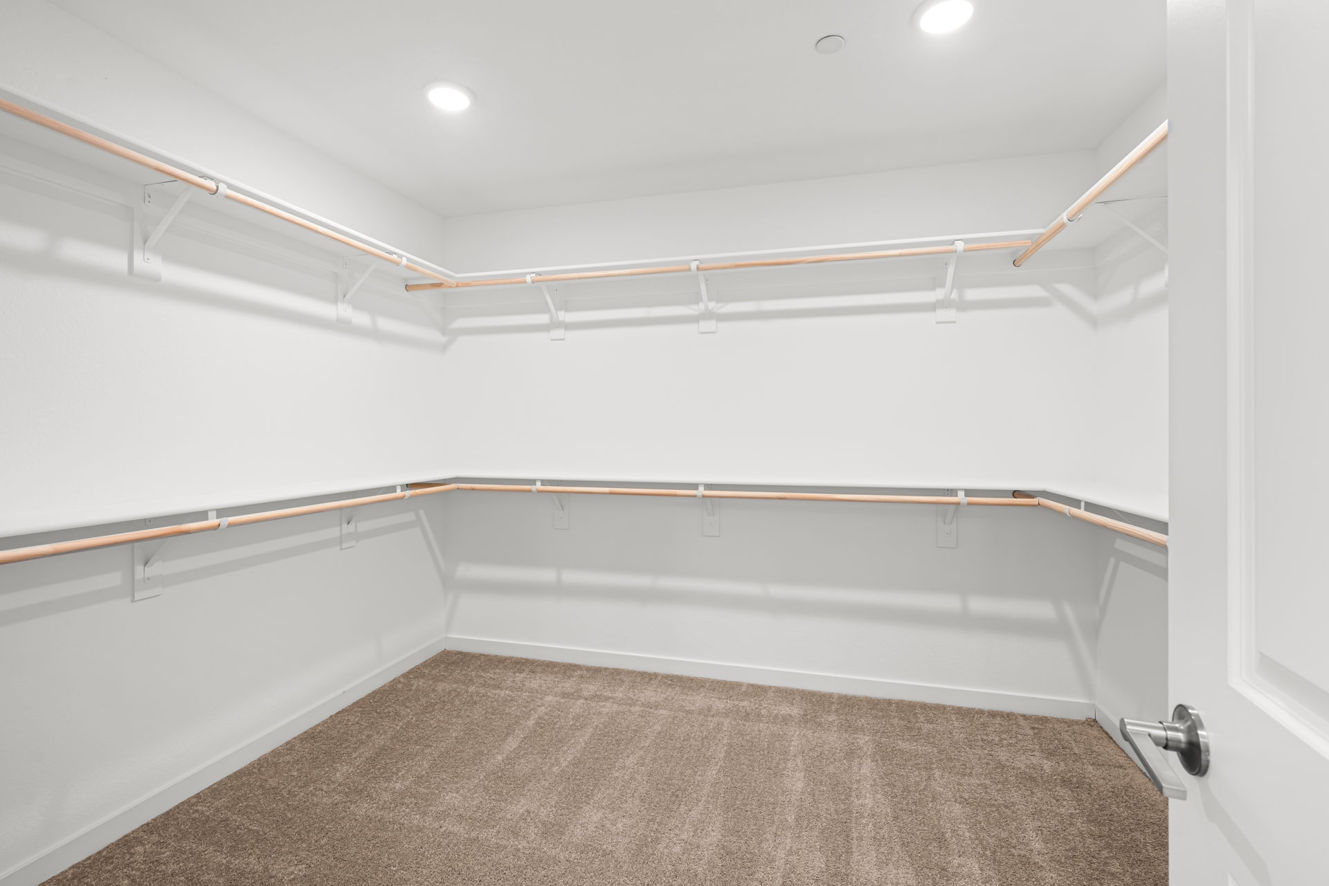 A white room with a carpet.