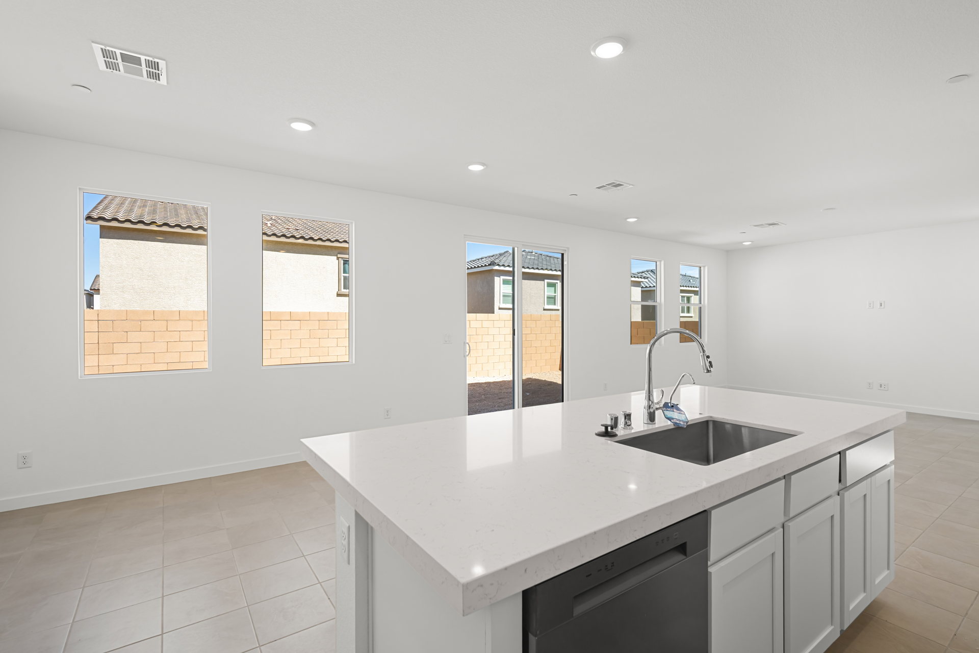 A kitchen with a sink and a large window.