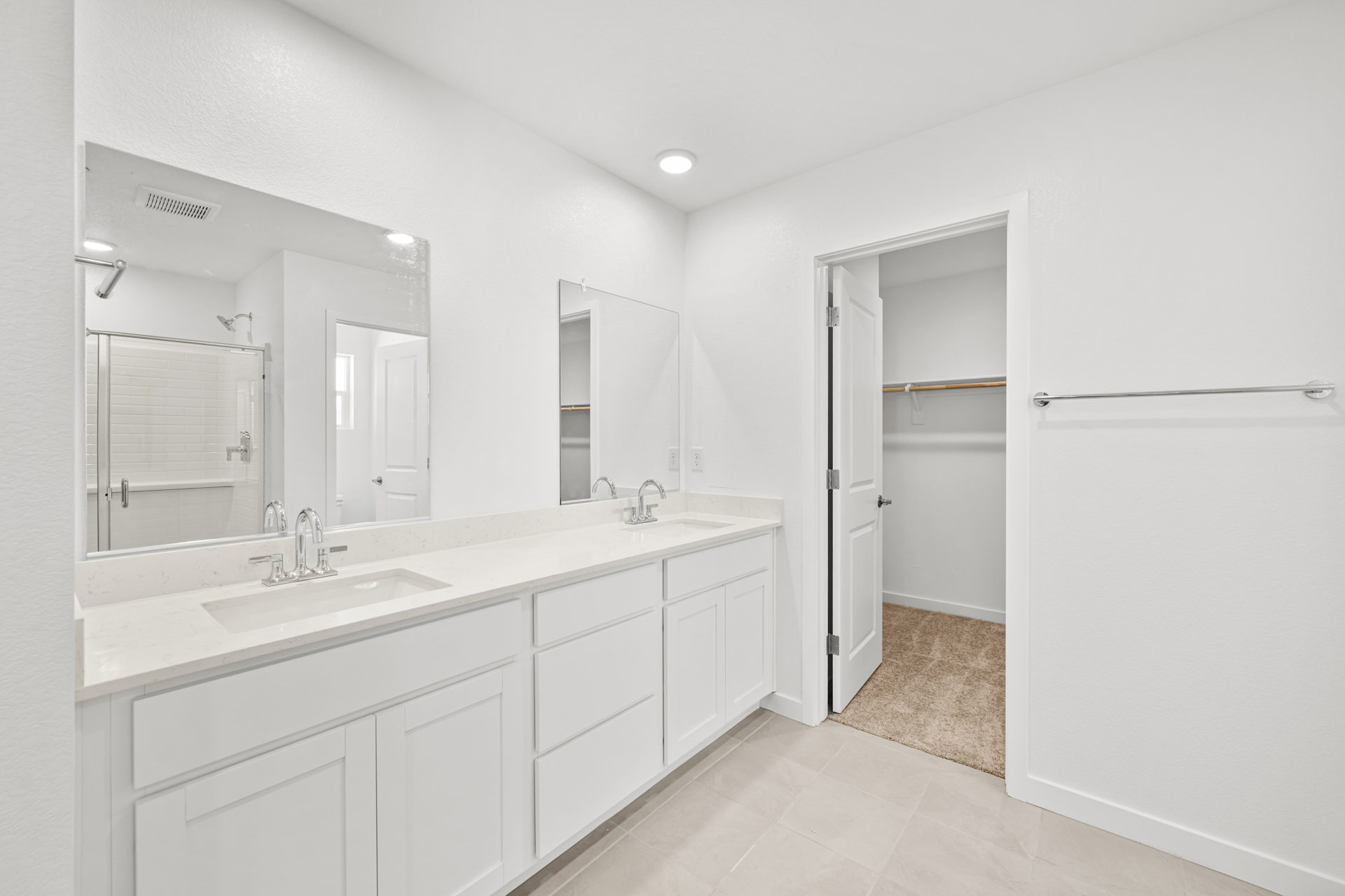 A bathroom with white cabinets.
