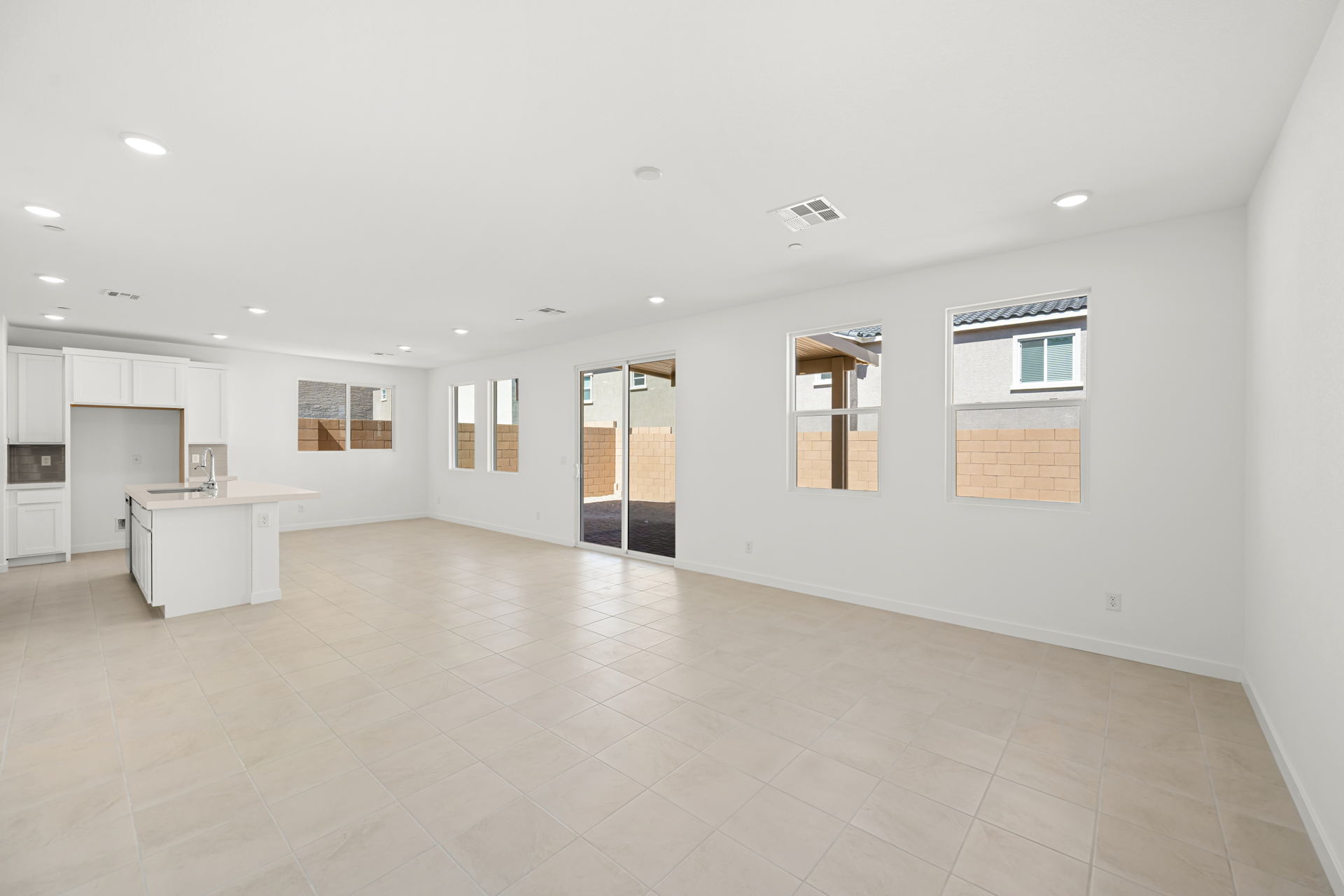 A large empty room with white tile.