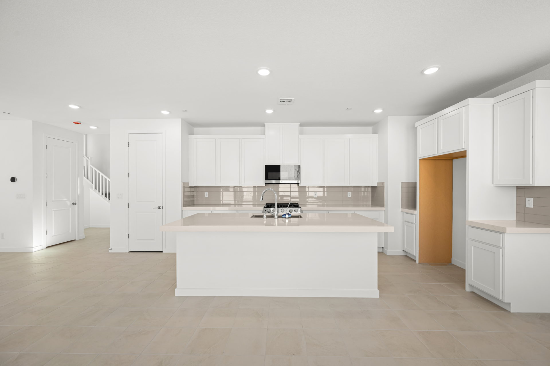 A kitchen with white cabinets.