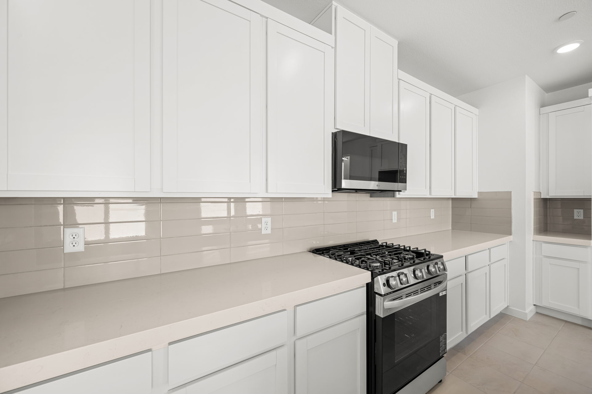 A kitchen with white cabinets.