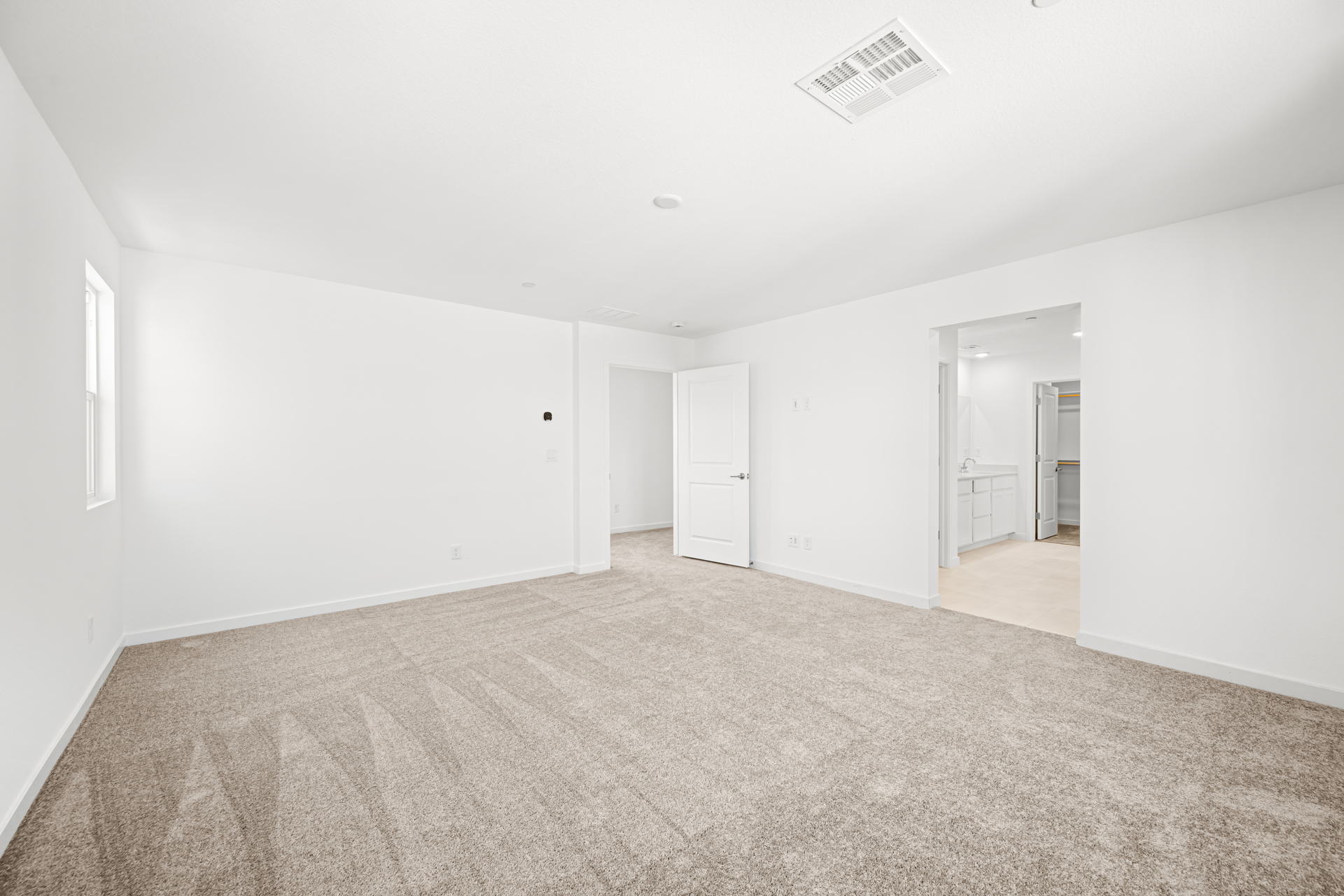 A long hallway with white doors.
