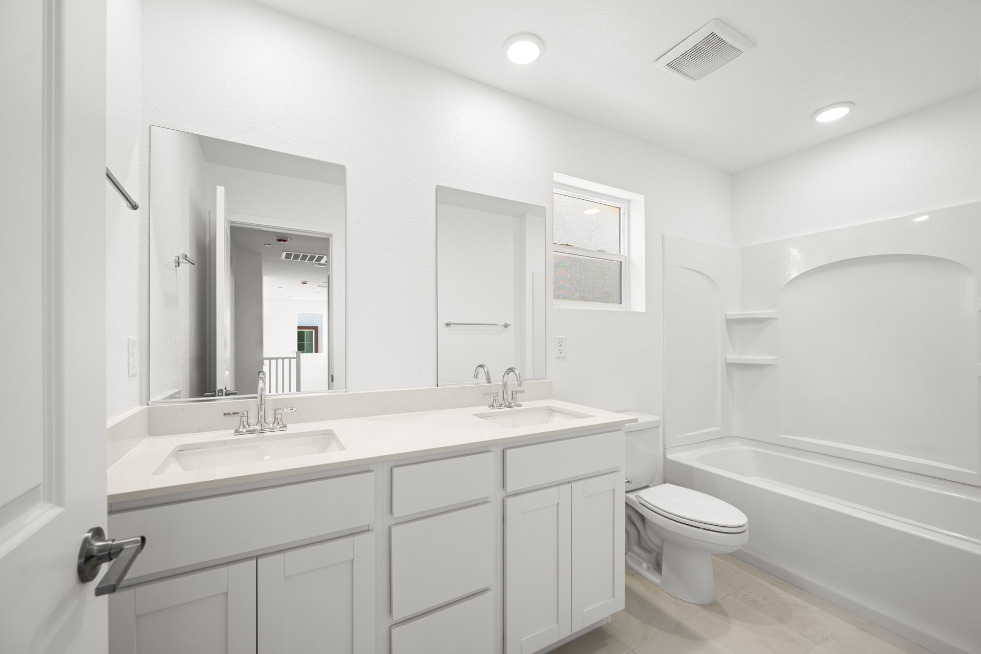 A bathroom with a tub sink and toilet.