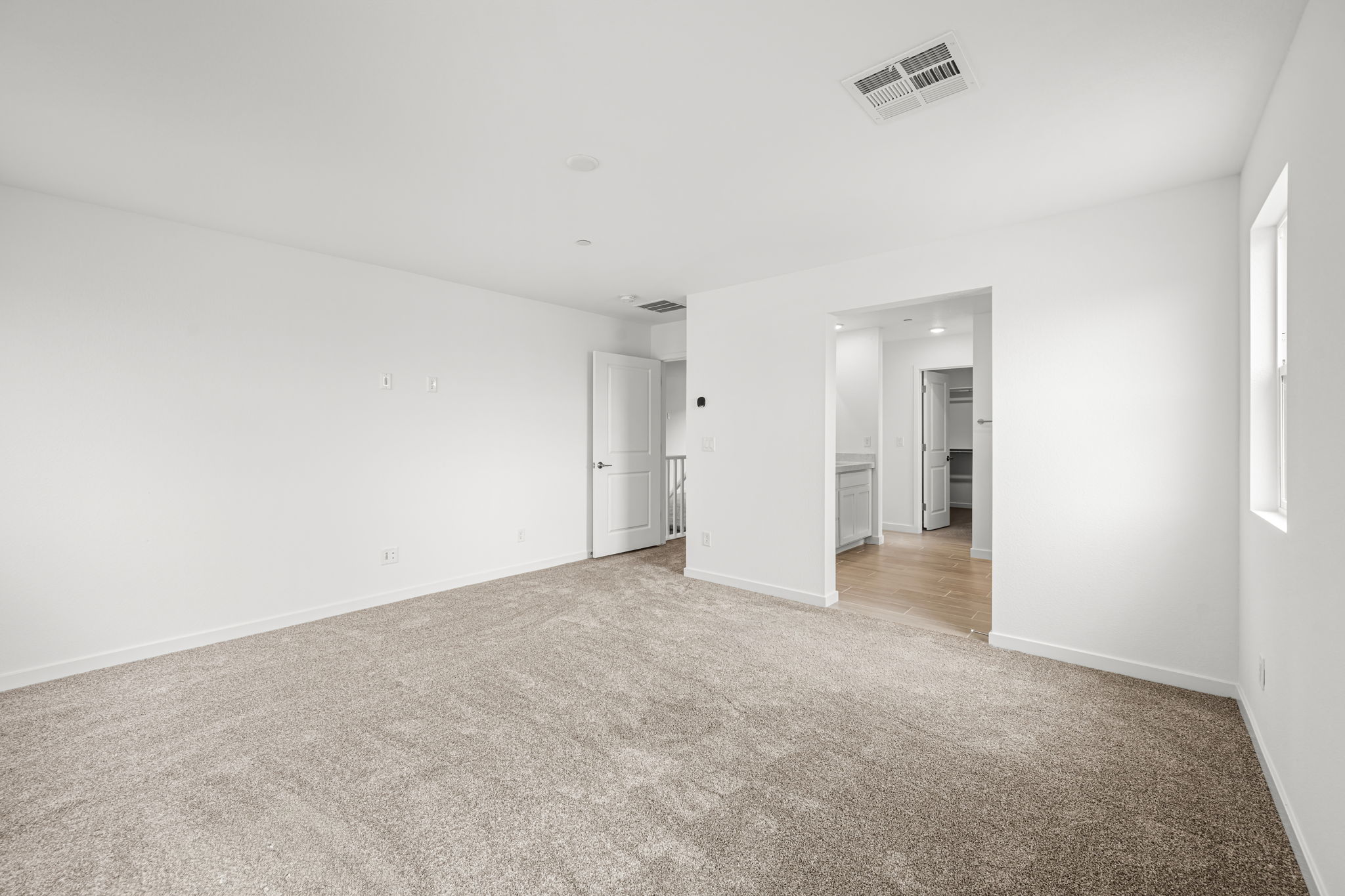 A long hallway with white walls.