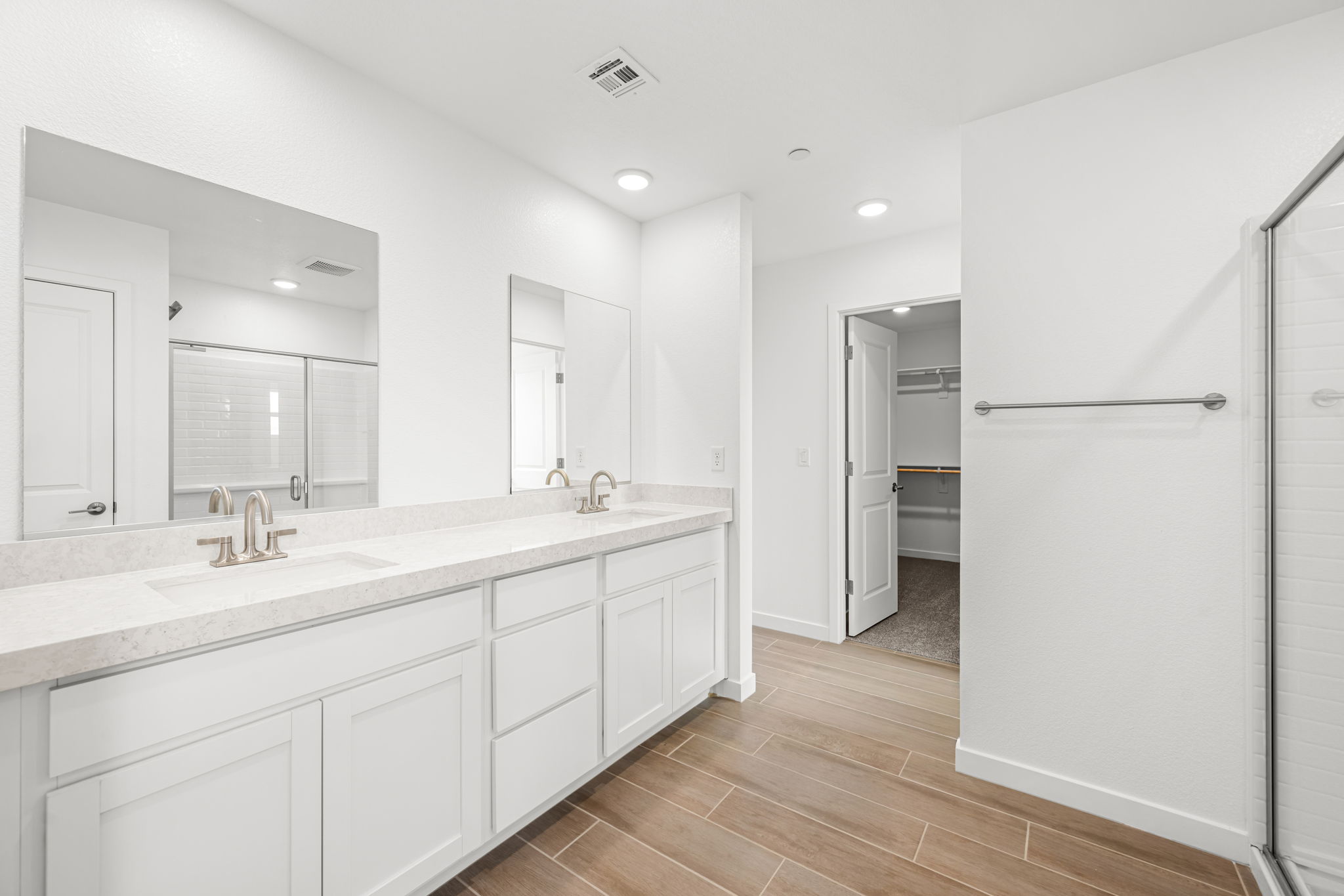 A bathroom with white cabinets.