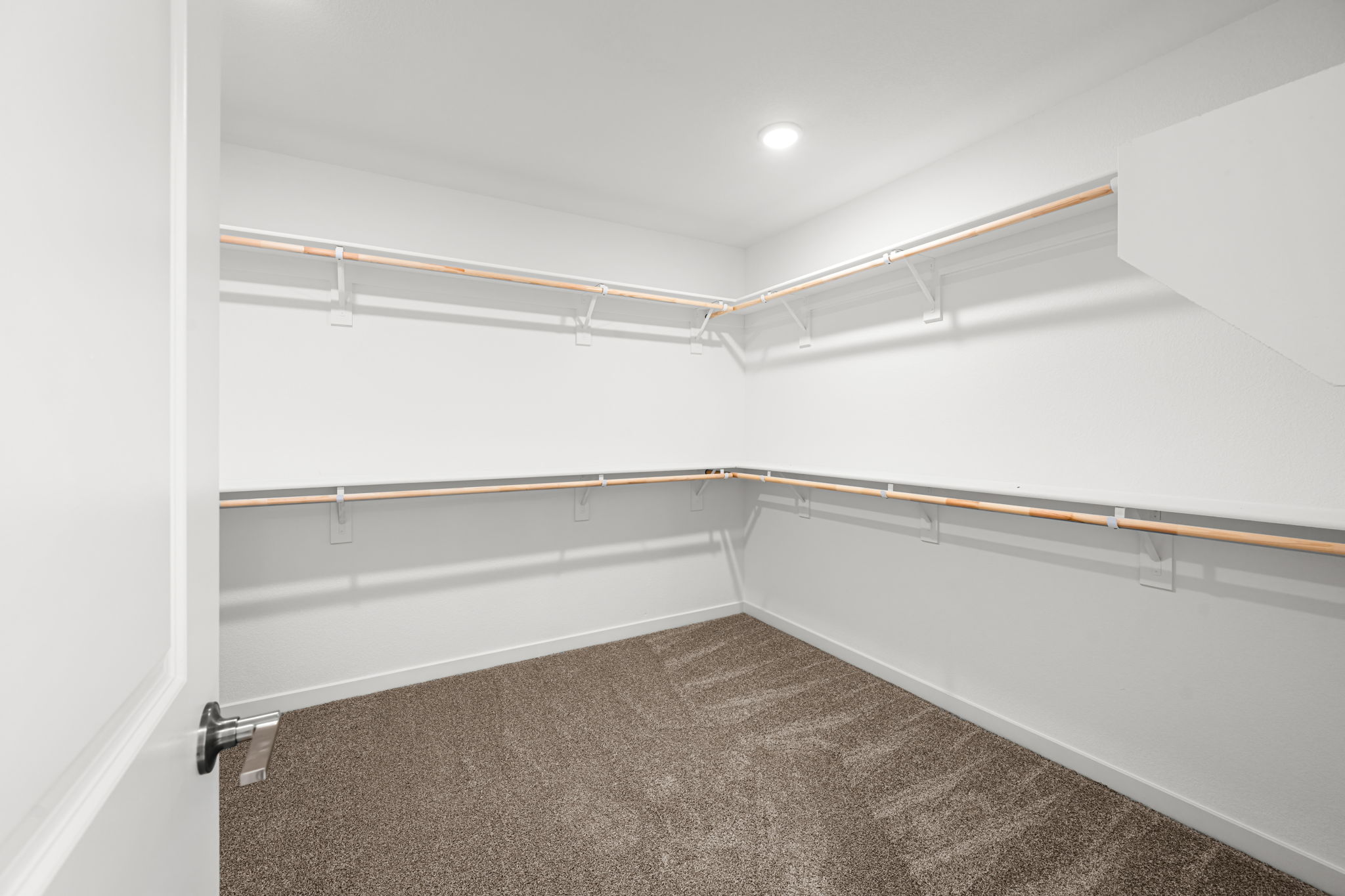 A white room with a carpet.