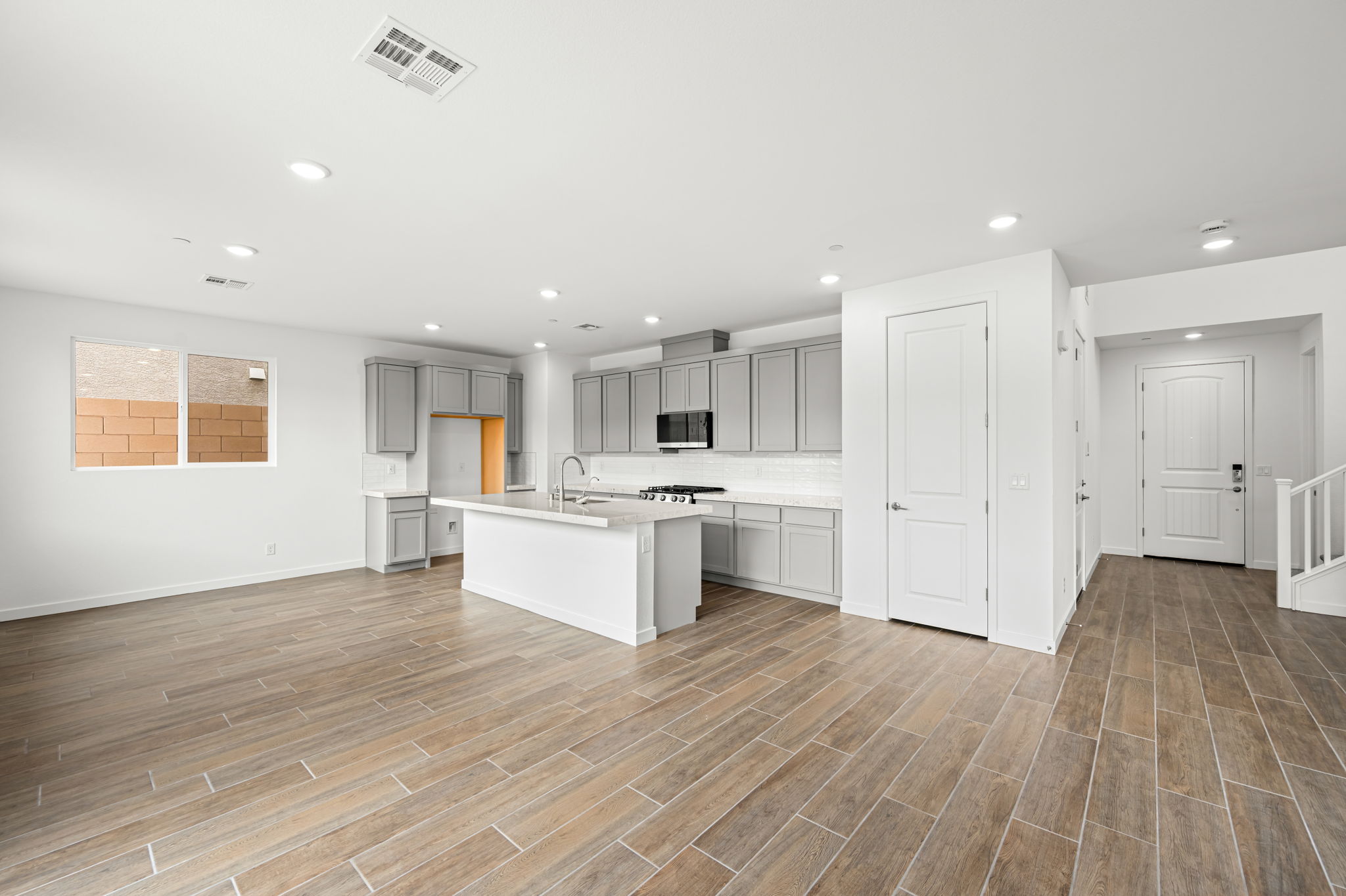 A large kitchen with white cabinets.