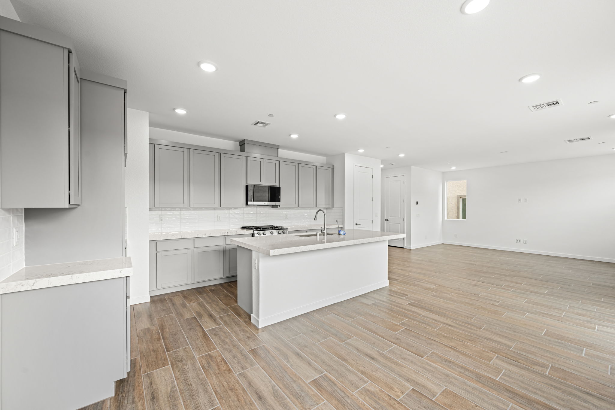 A kitchen with white cabinets.