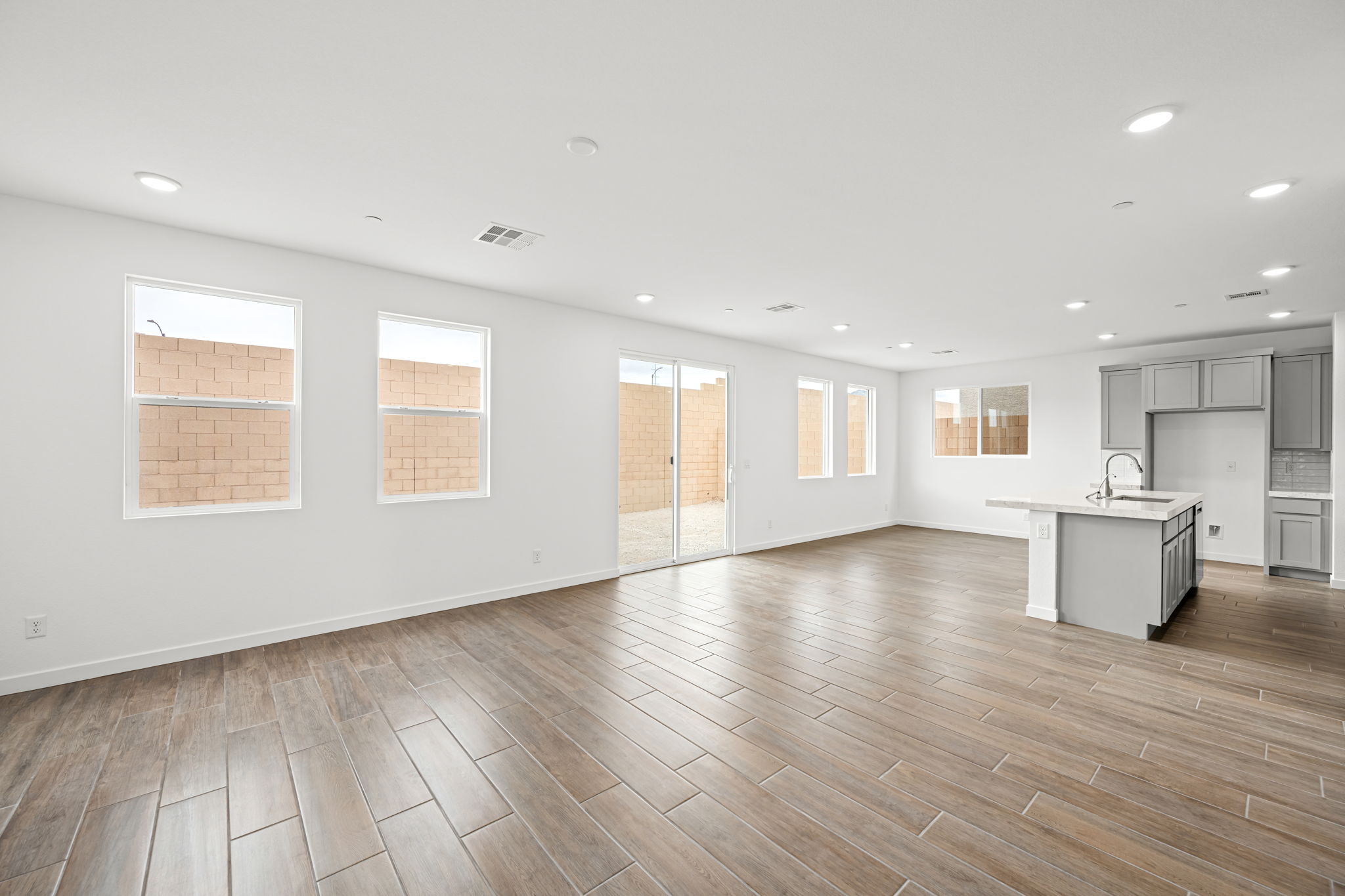 A large empty room with a wood floor and a wood floor.
