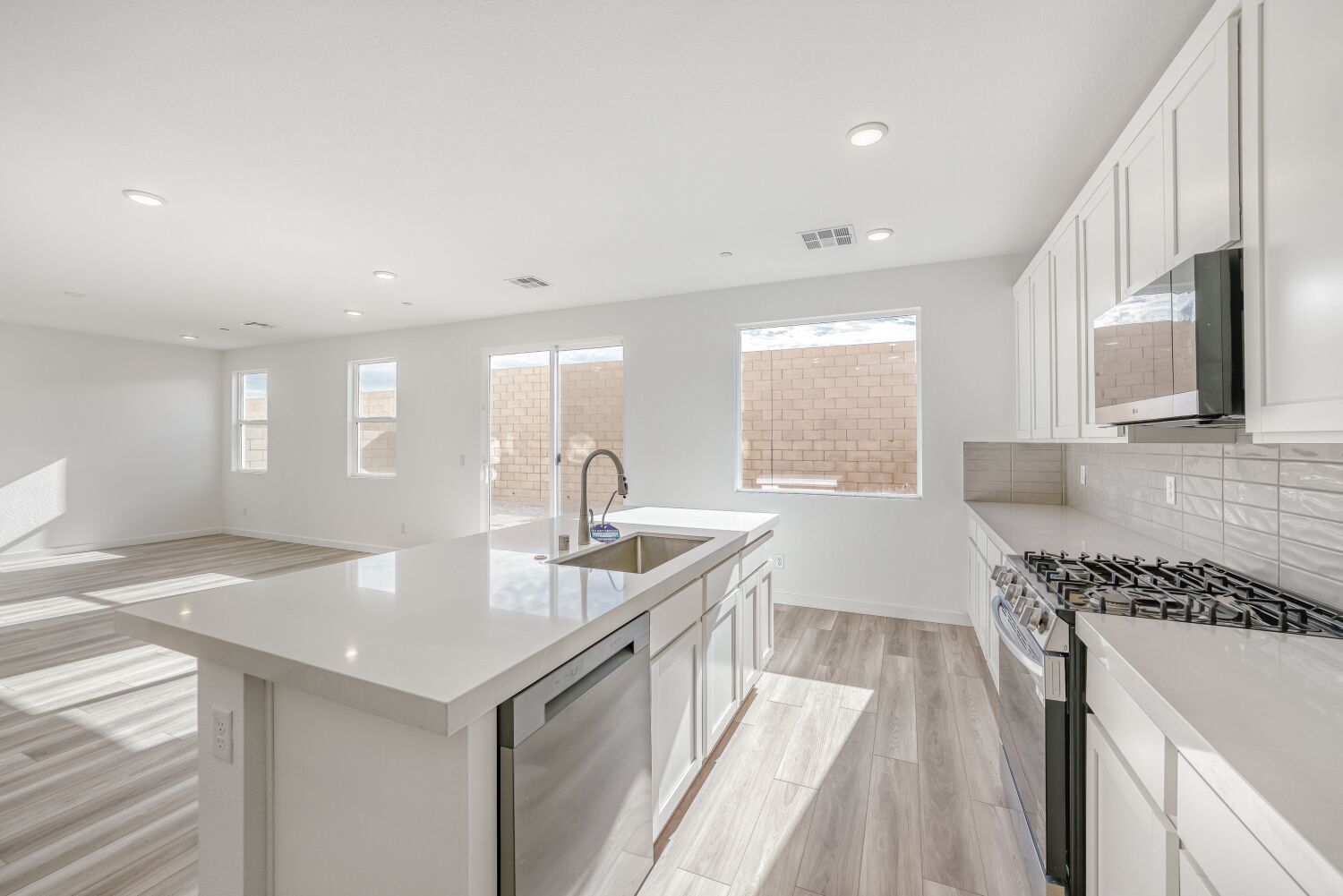 A kitchen with white cabinets.