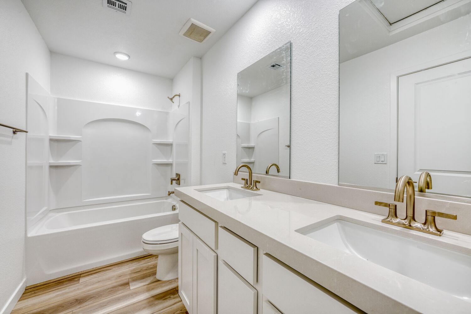 A bathroom with a tub sink and toilet.