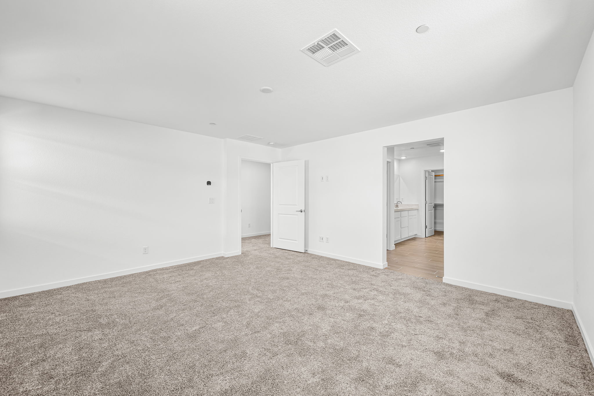 A hallway with white walls.