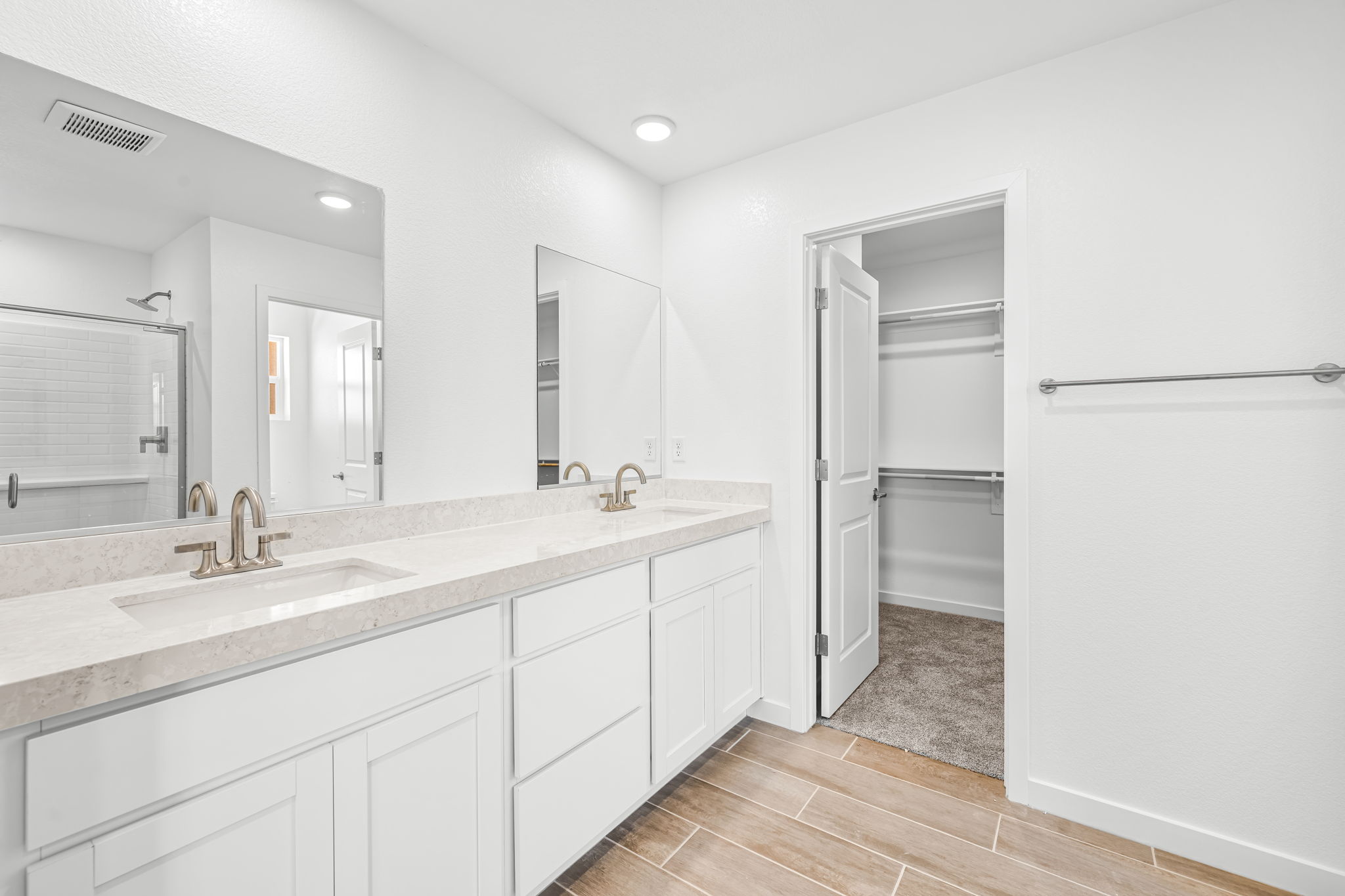 A bathroom with white cabinets.
