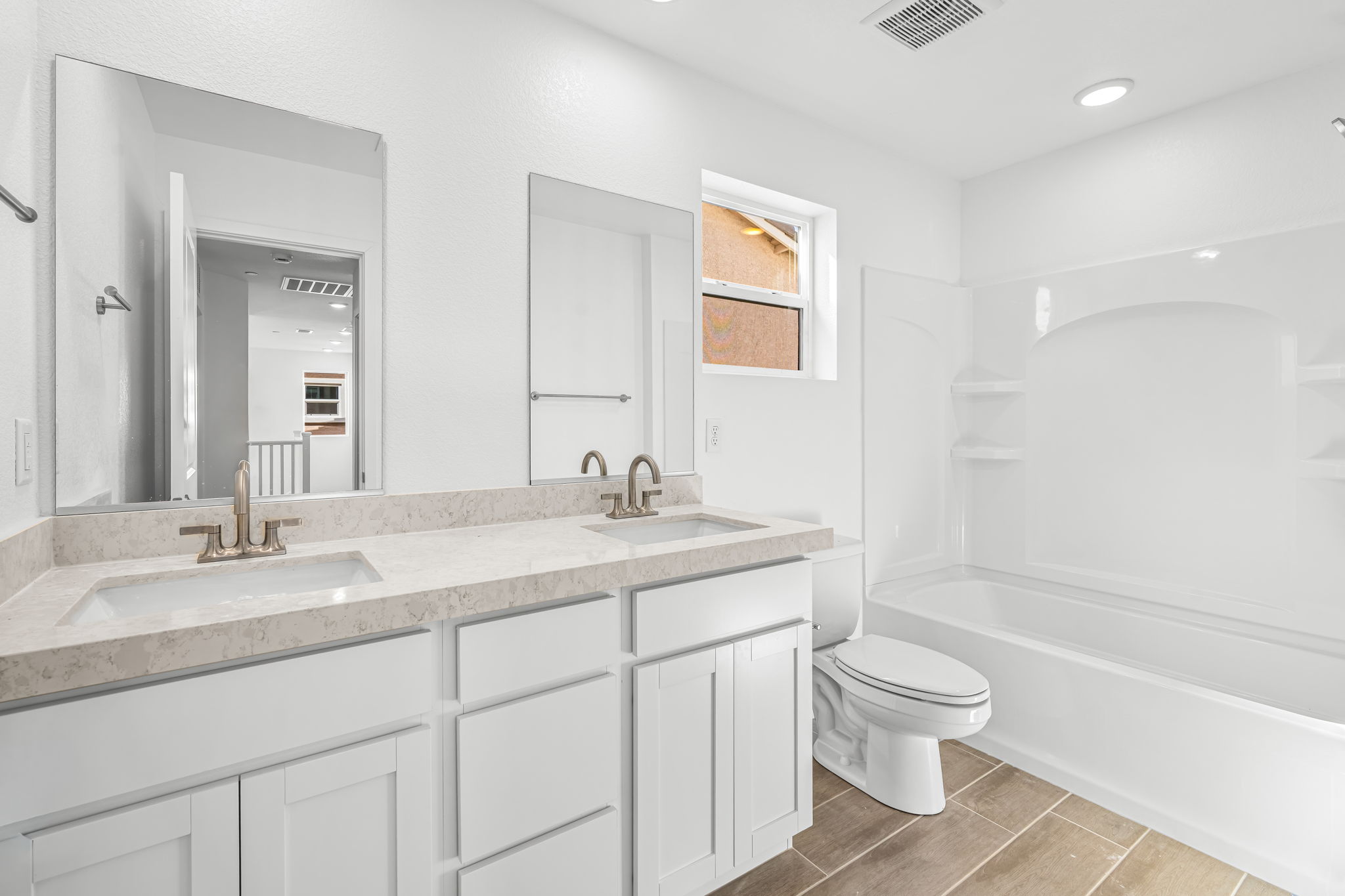A bathroom with a tub sink and toilet.