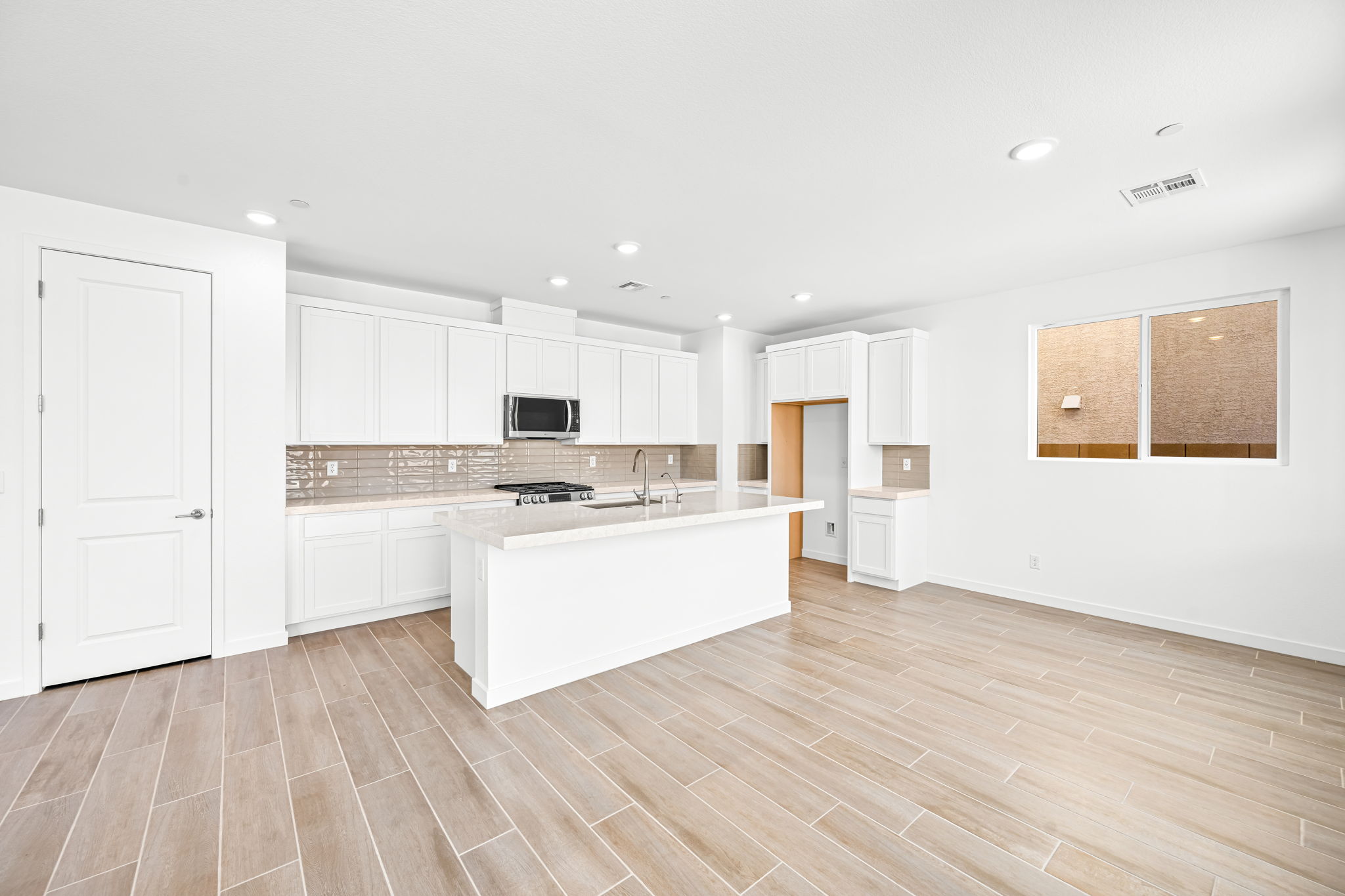 A kitchen with white cabinets.