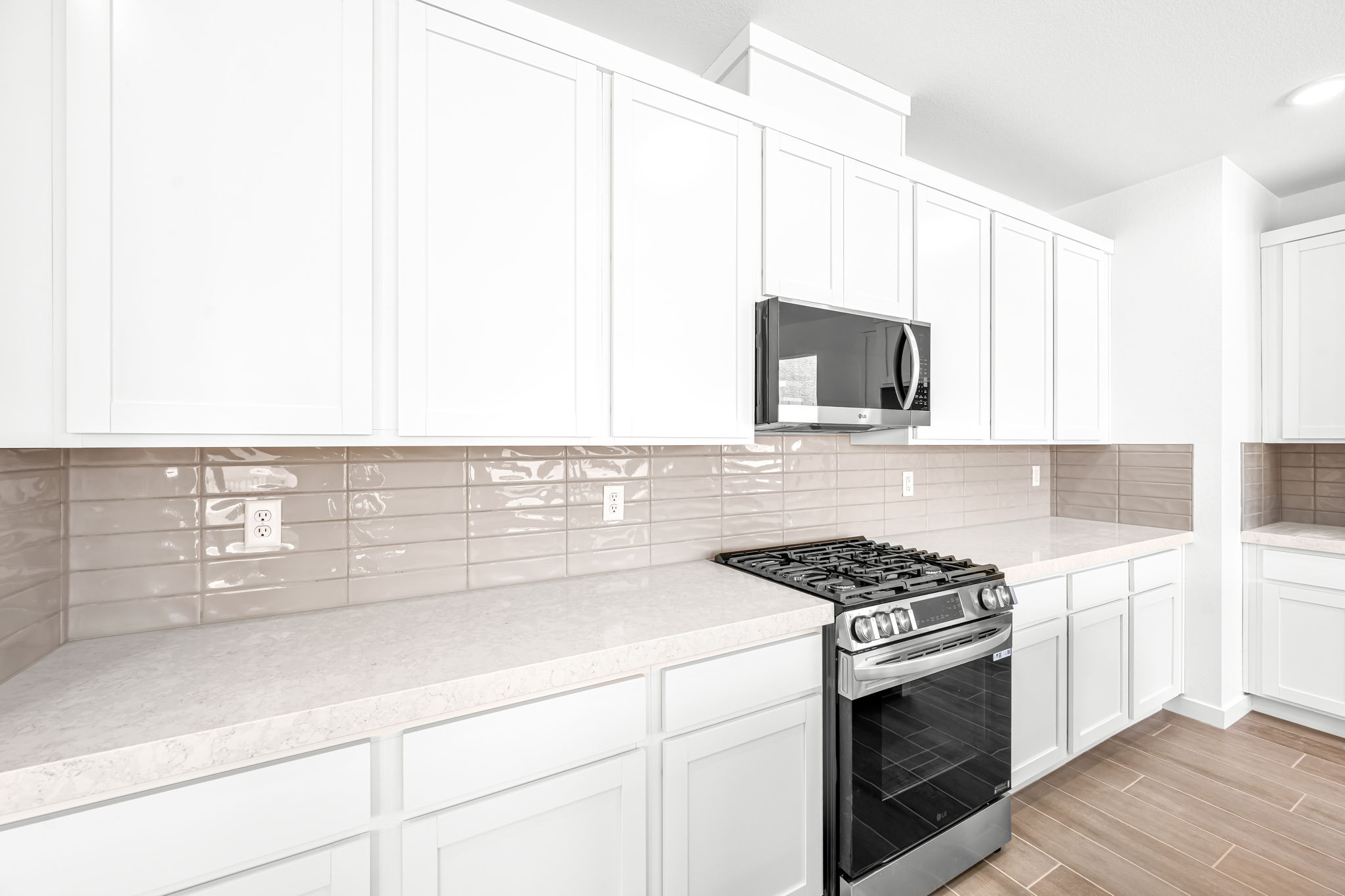 A kitchen with white cabinets.