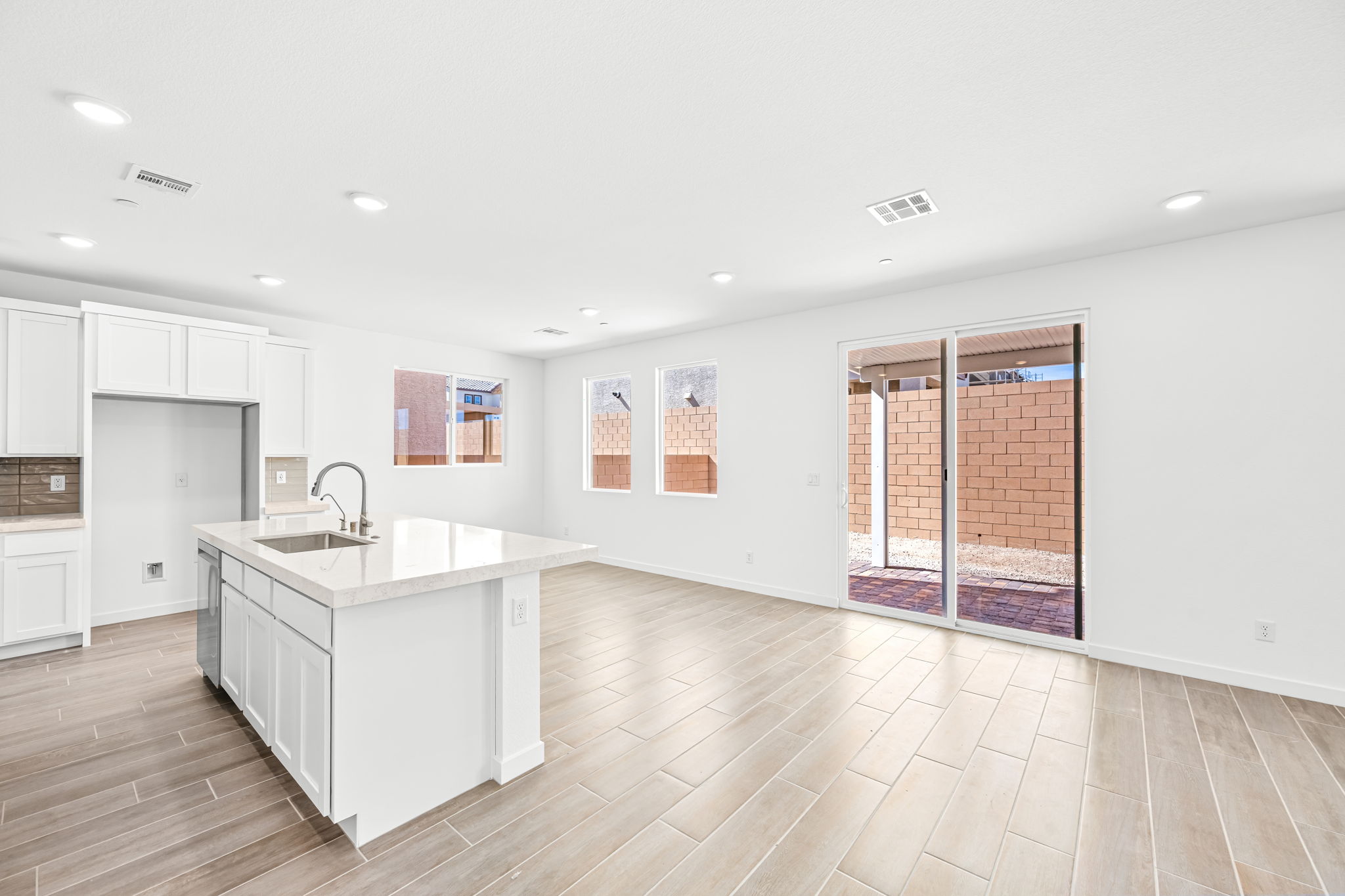A kitchen with white cabinets.