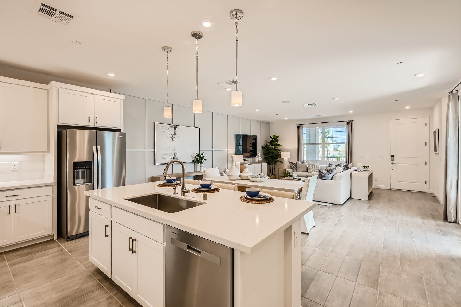 A kitchen with white cabinets.
