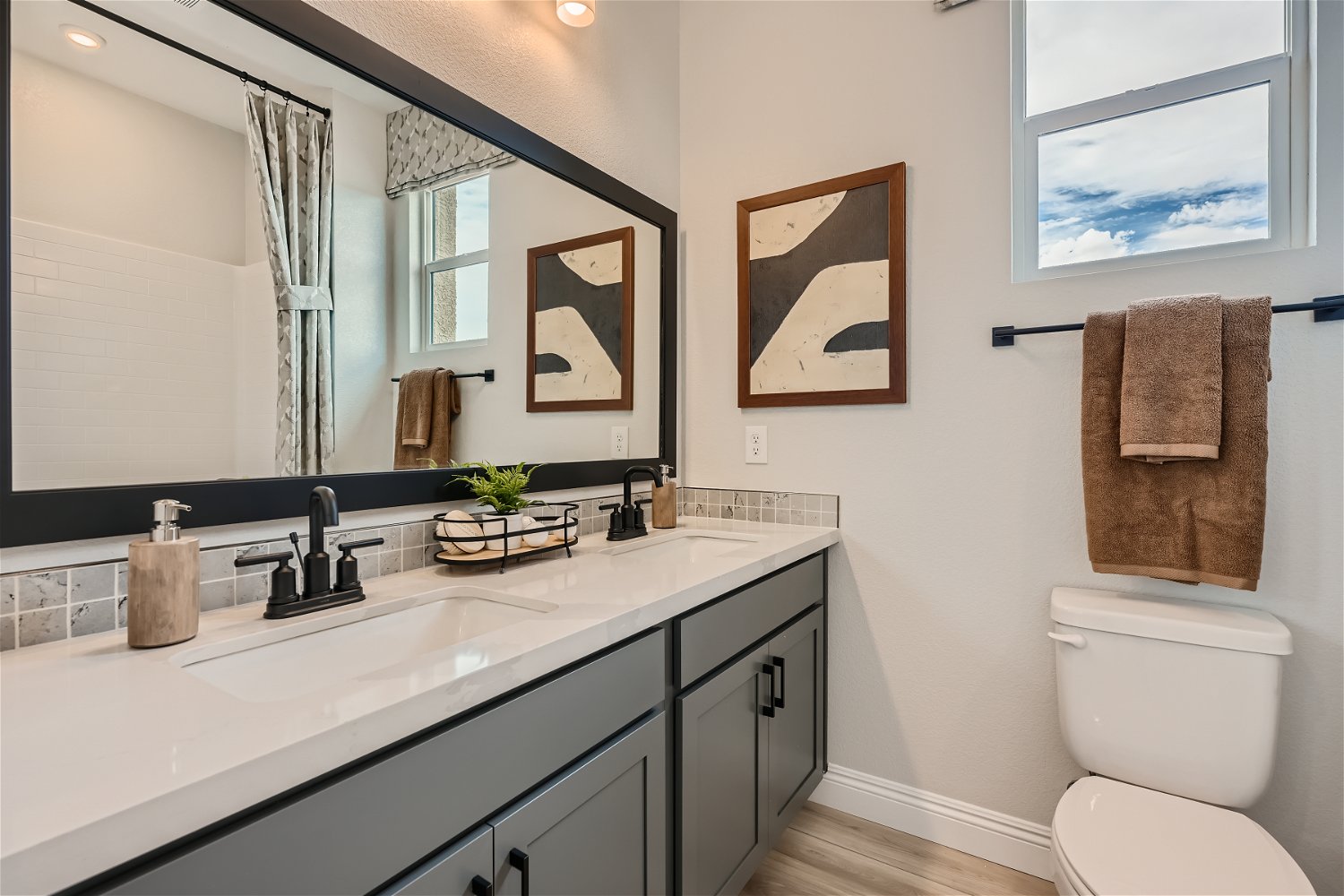 A bathroom with a large mirror.