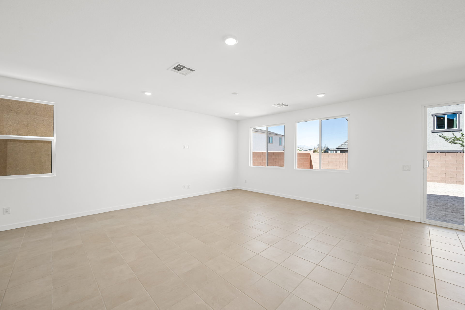 A room with a tile floor and windows.