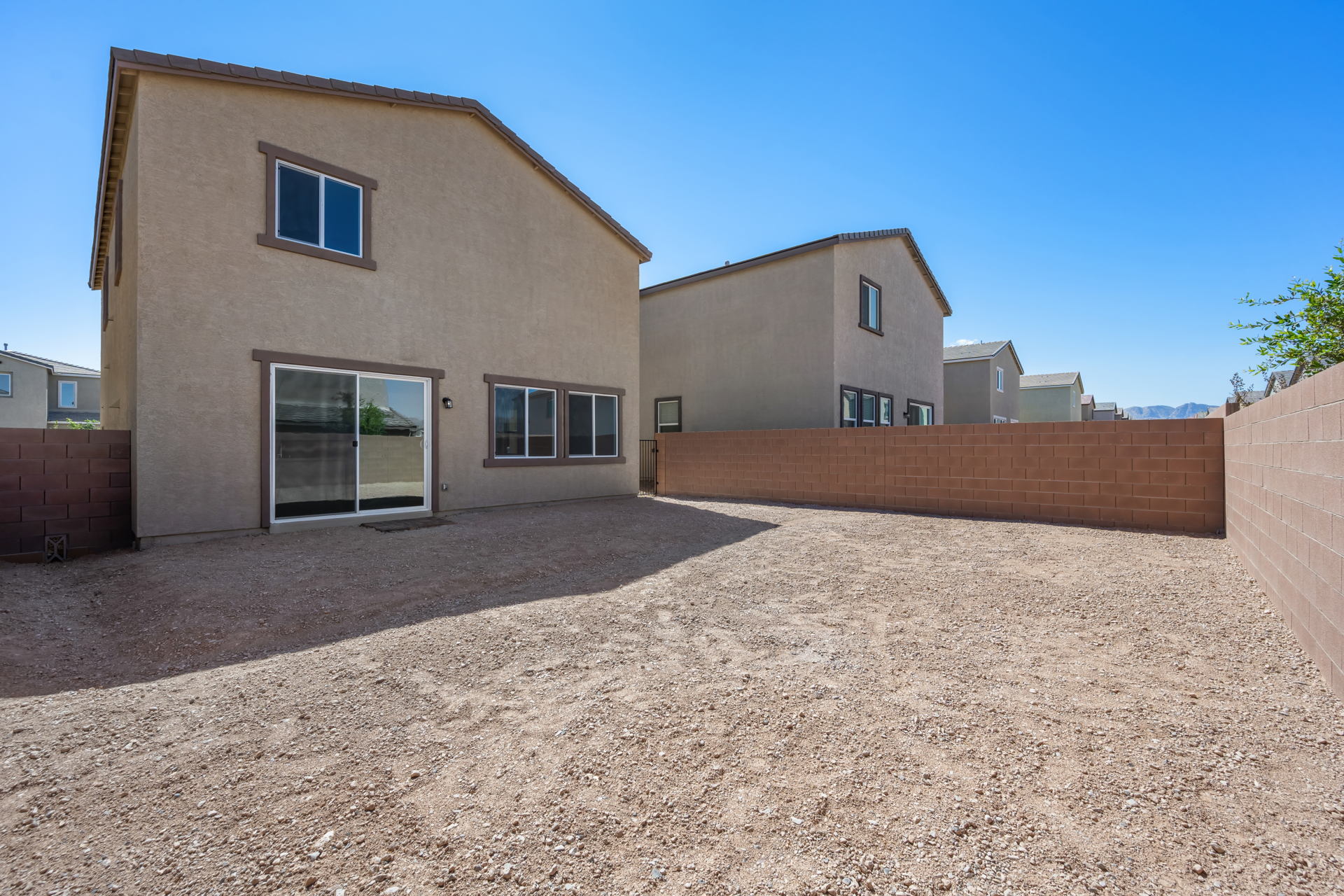 A building with a dirt yard.