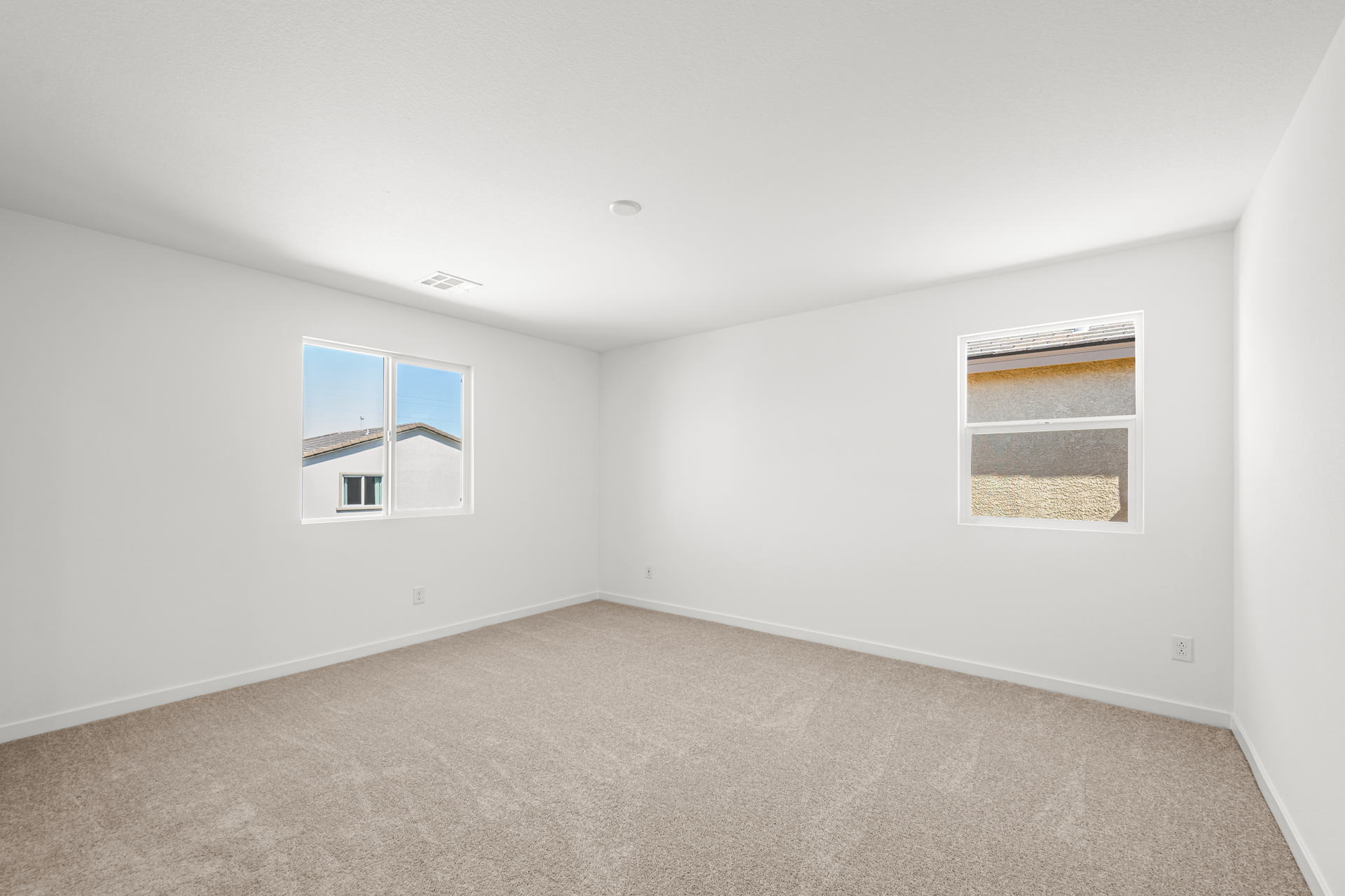 A room with a window and a carpet.