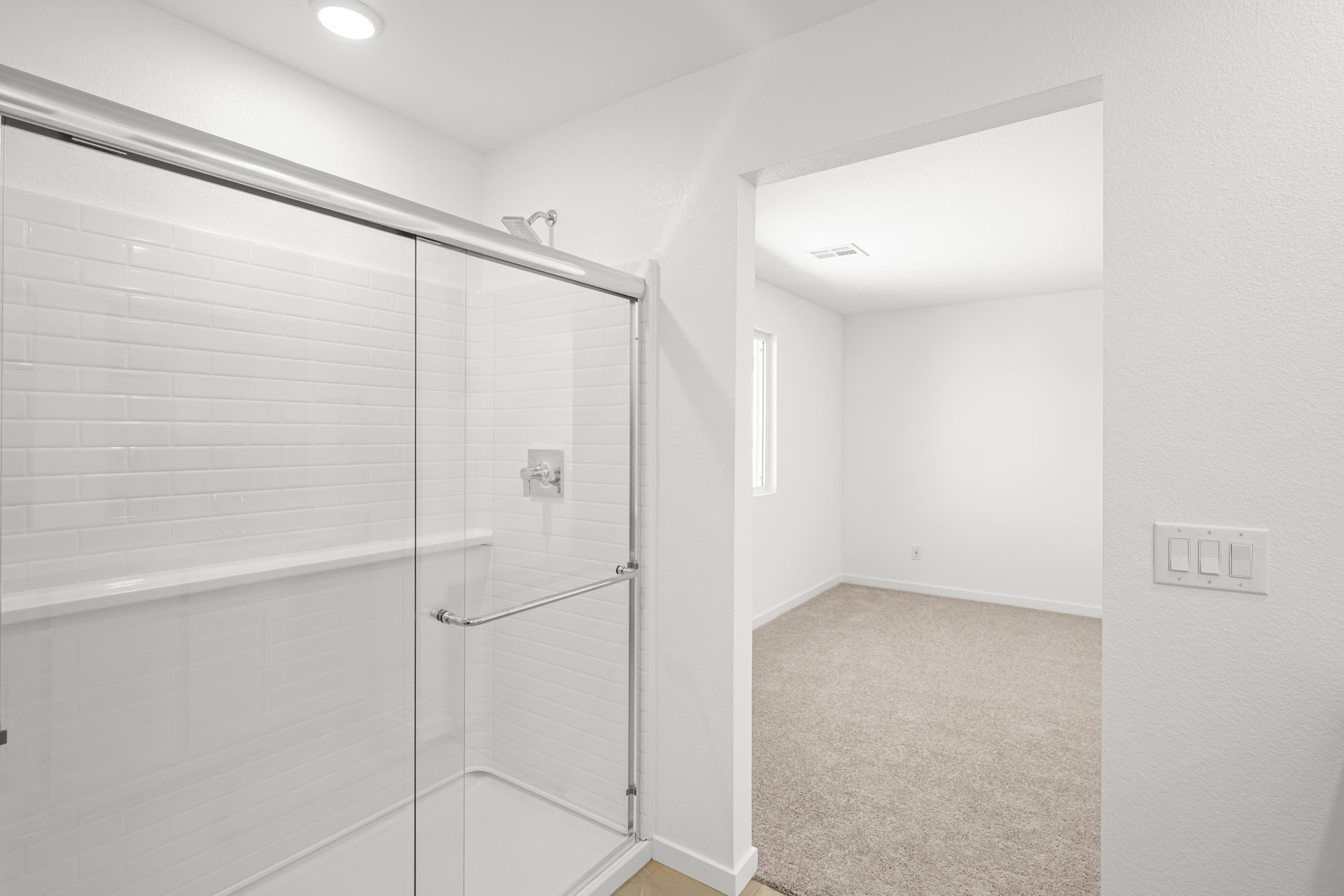 A bathroom with a shower unit.