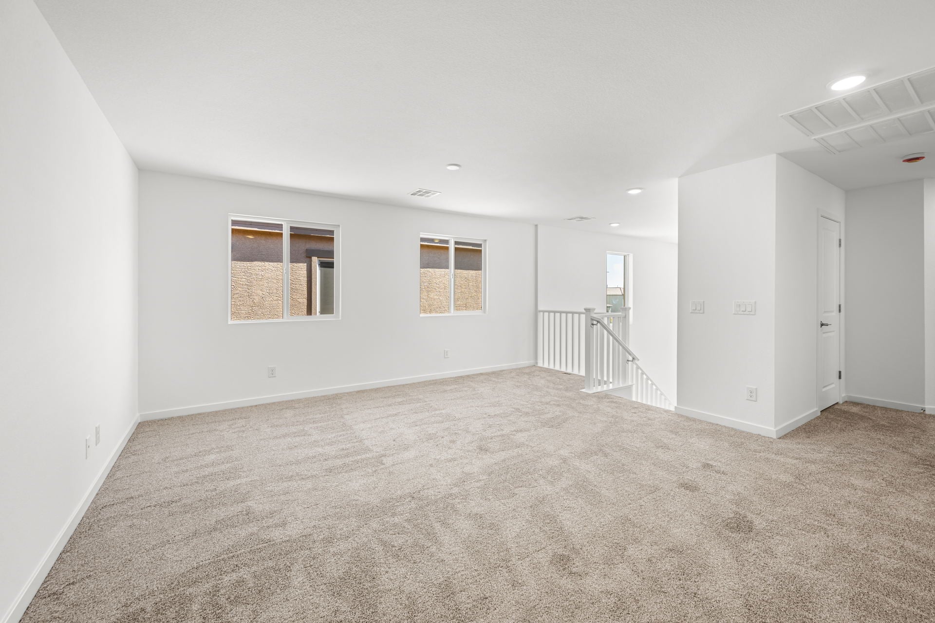 A room with white walls and a carpeted floor.