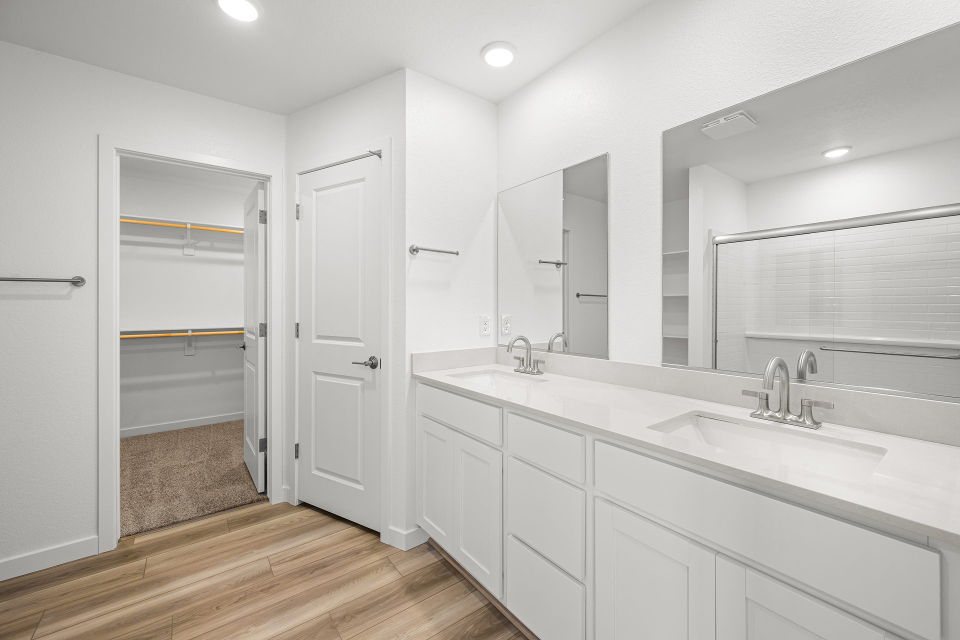 A bathroom with white cabinets.
