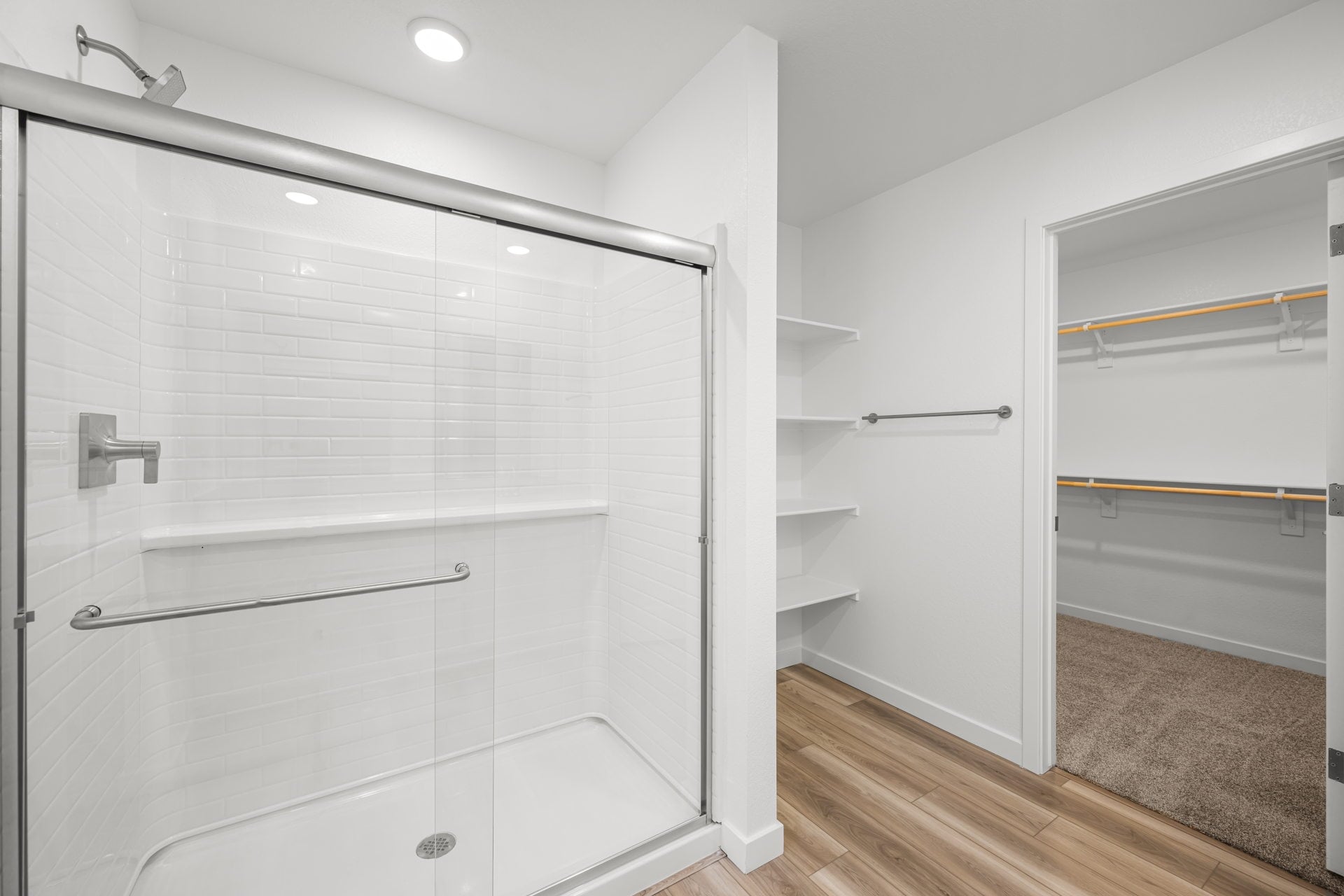 A shower with a glass door.