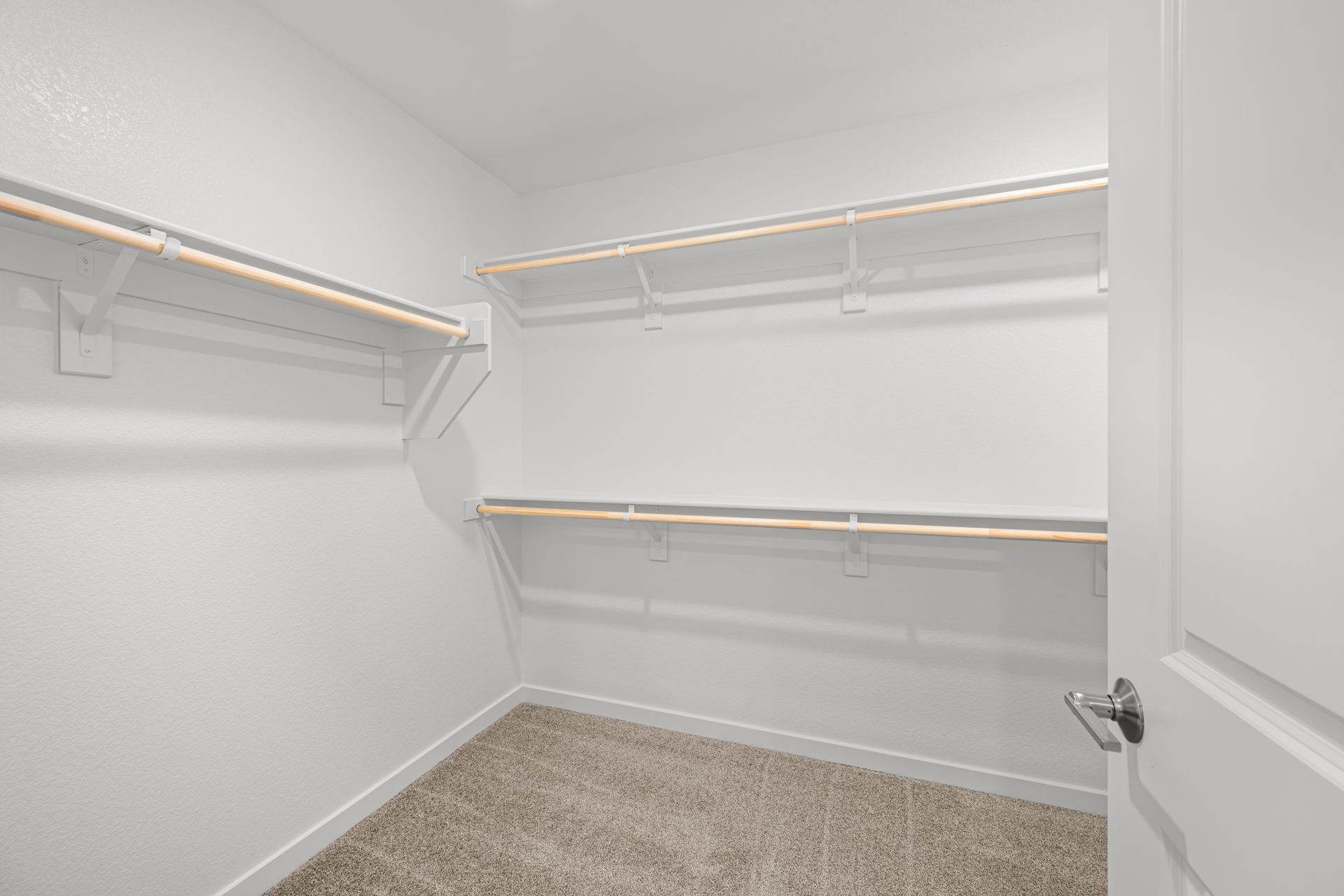 A white door with a metal bar.