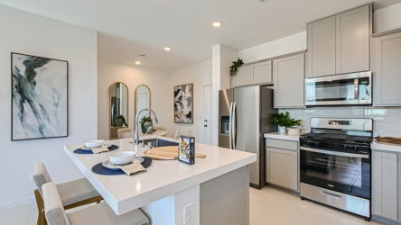 A kitchen with white cabinets.