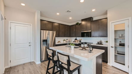 A kitchen with a marble island.