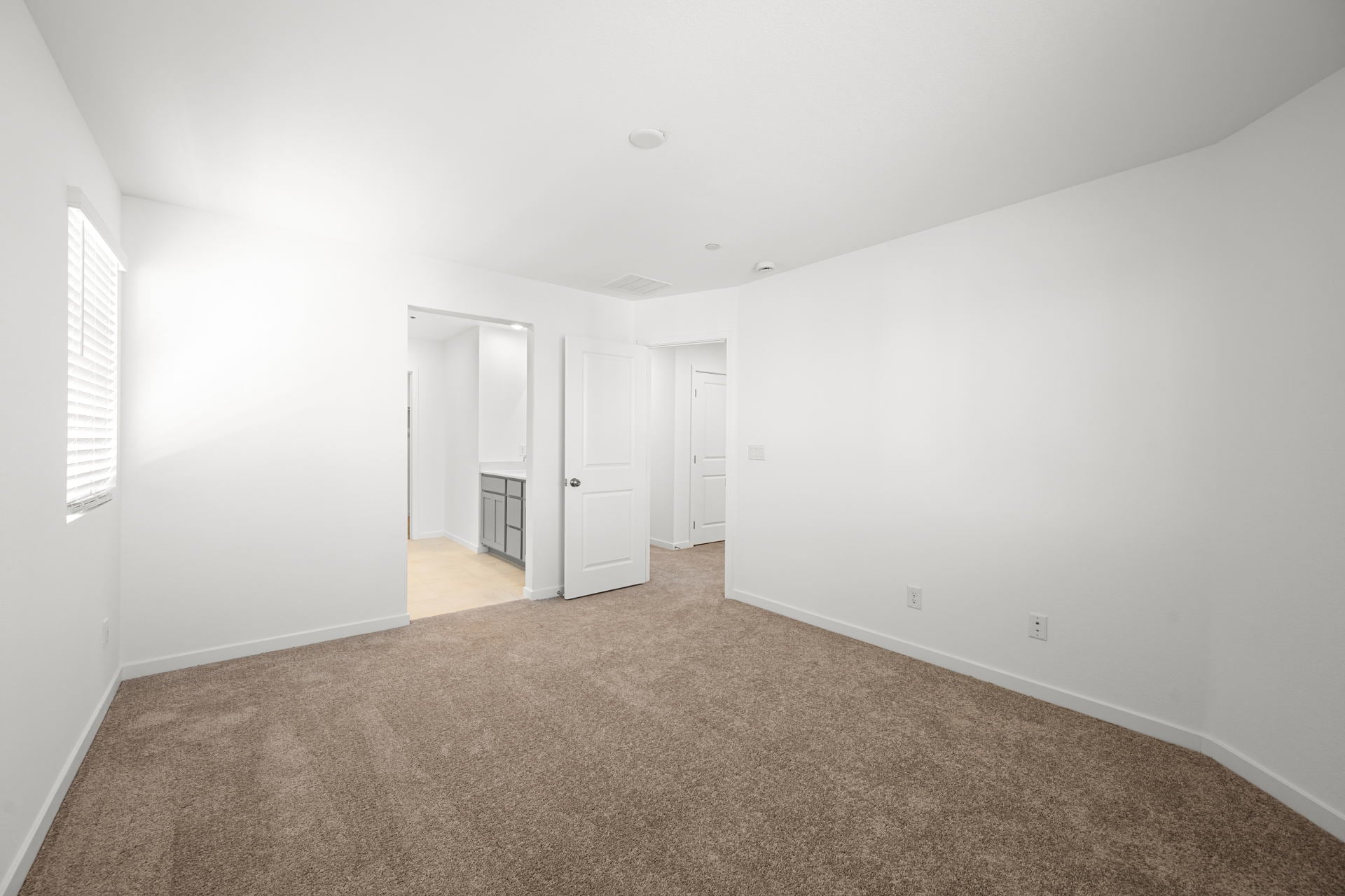 A hallway with white walls.
