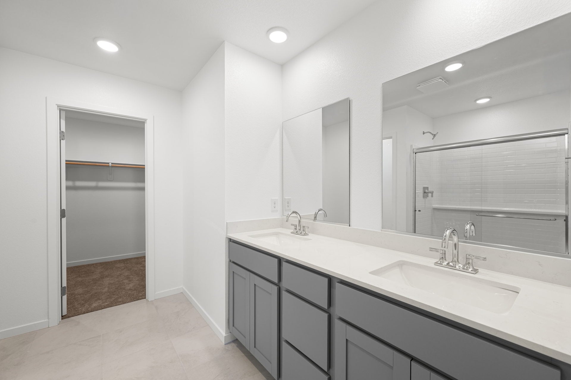 A bathroom with a large mirror.