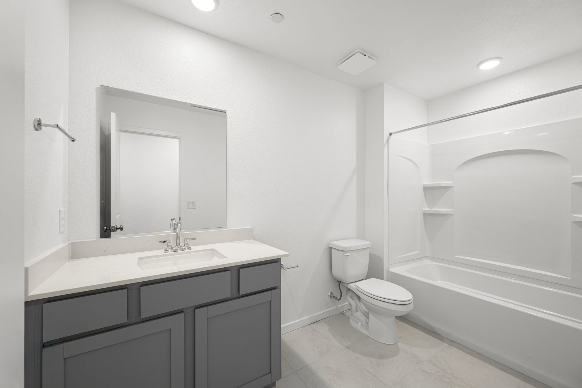 A bathroom with a tub sink and toilet.