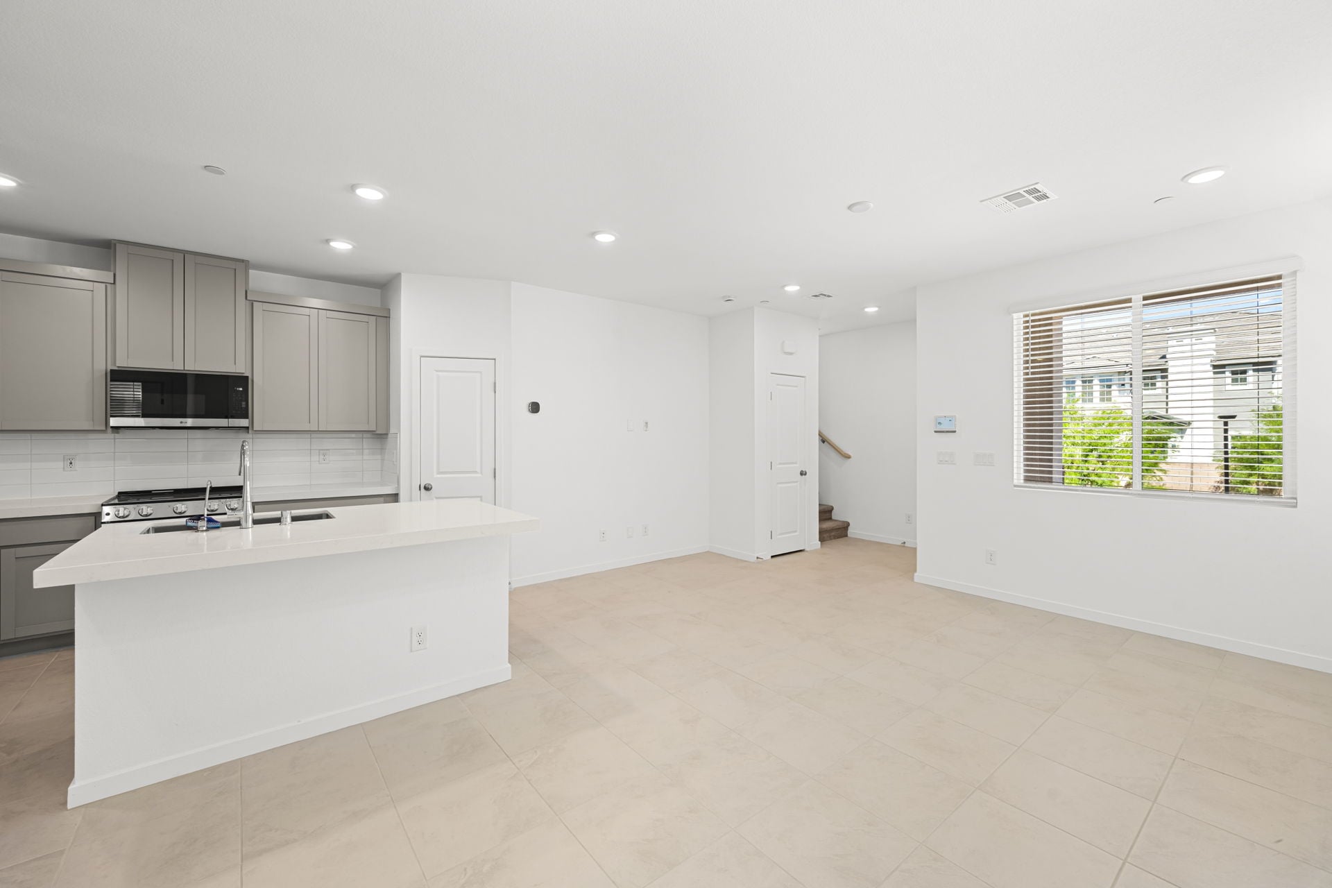 A kitchen with white cabinets.