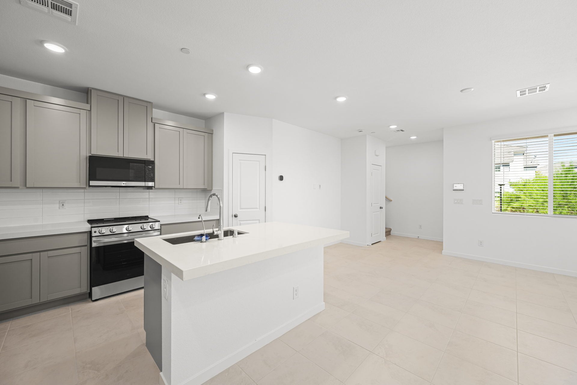 A kitchen with white cabinets.