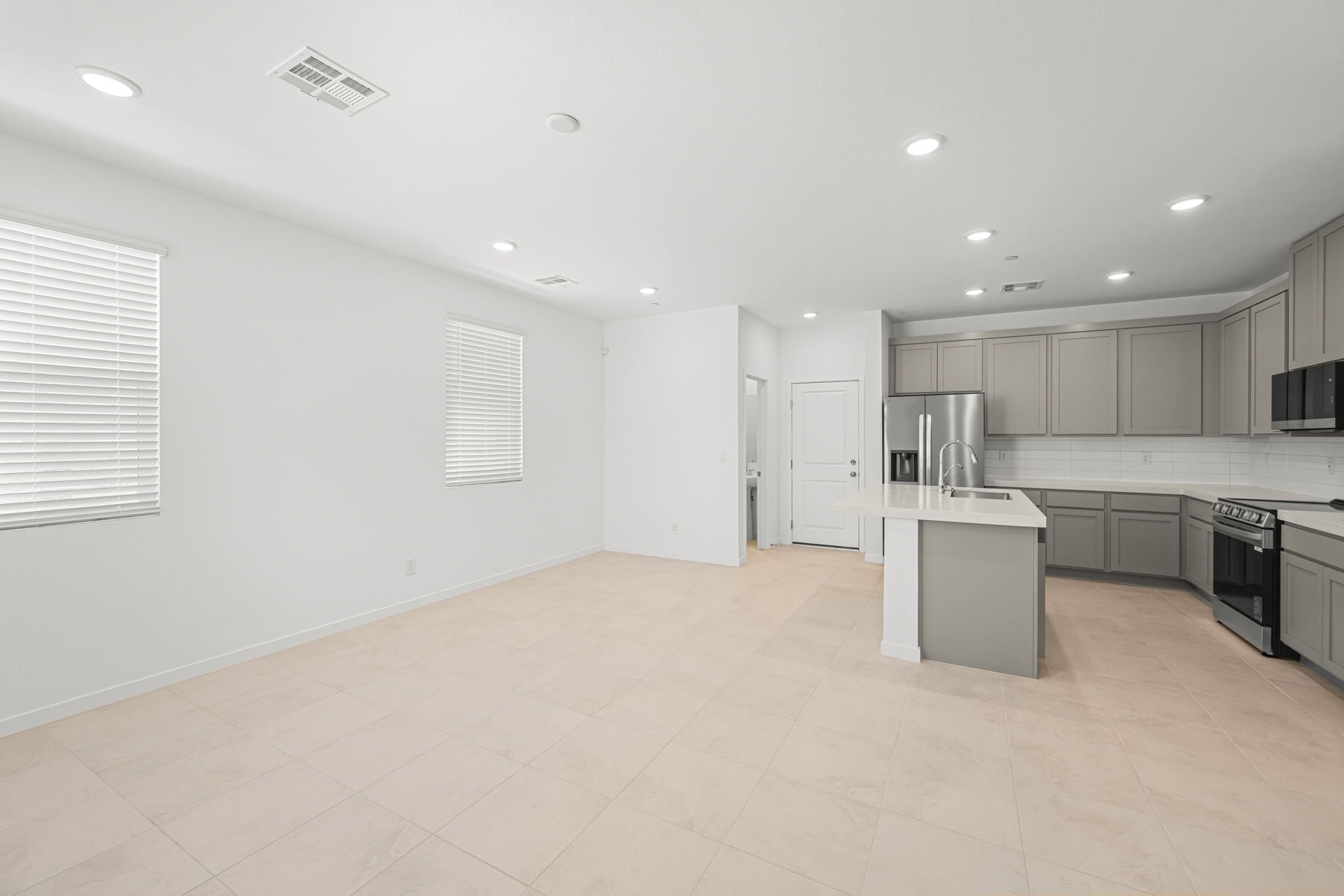 A kitchen with white cabinets.