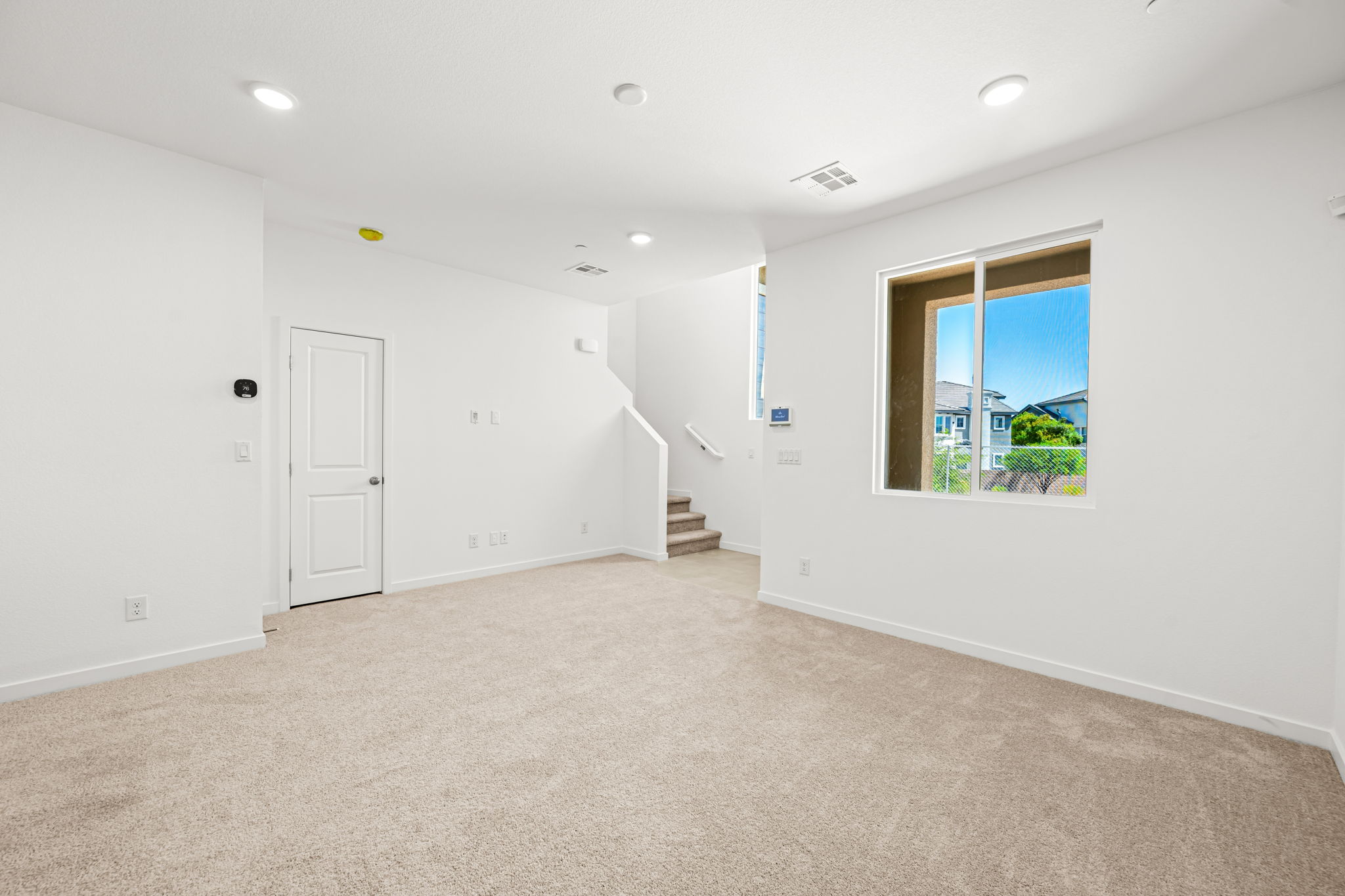 A room with white walls and a window.